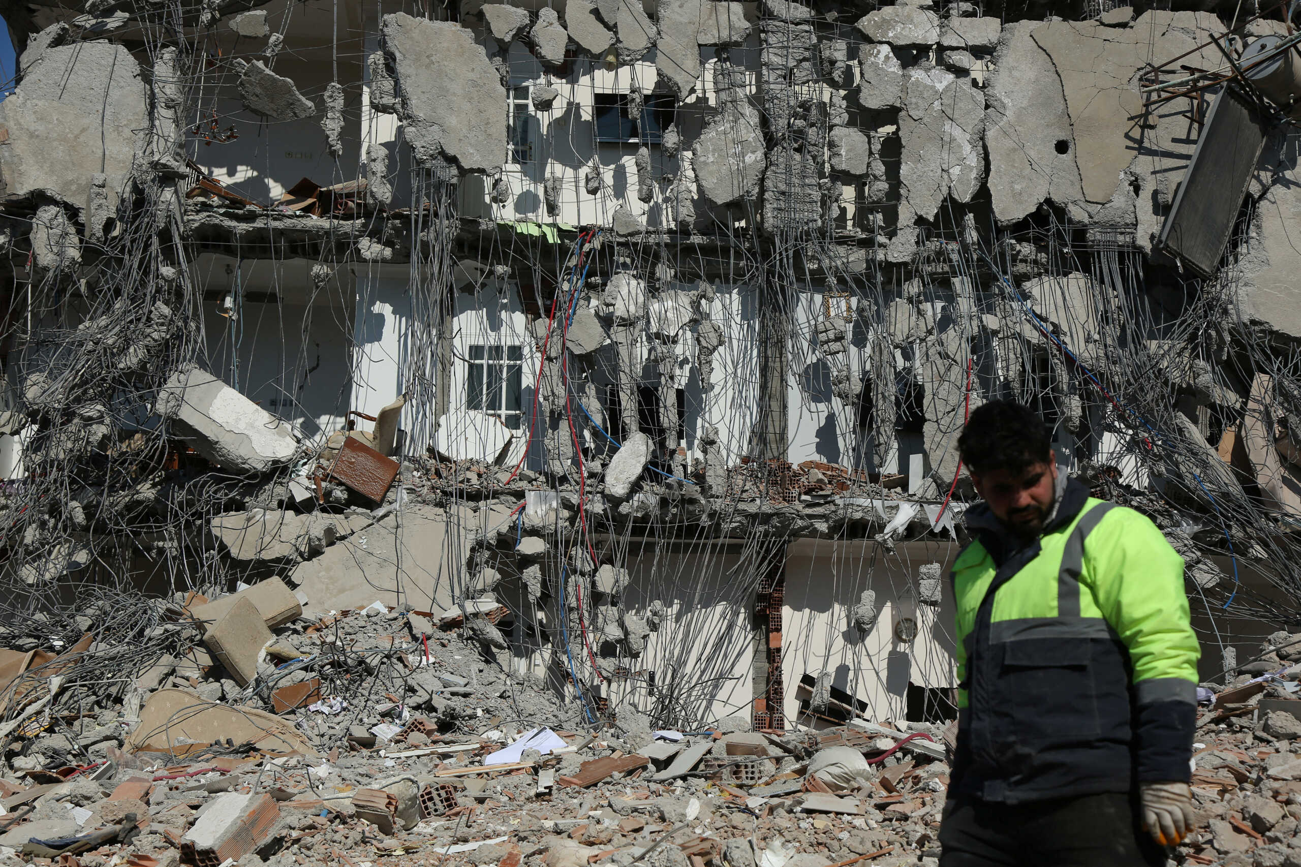 A rescuer walks past by a damaged building, in the aftermath of the deadly earthquake in Adiyaman, Turkey February 11, 2023. REUTERS
