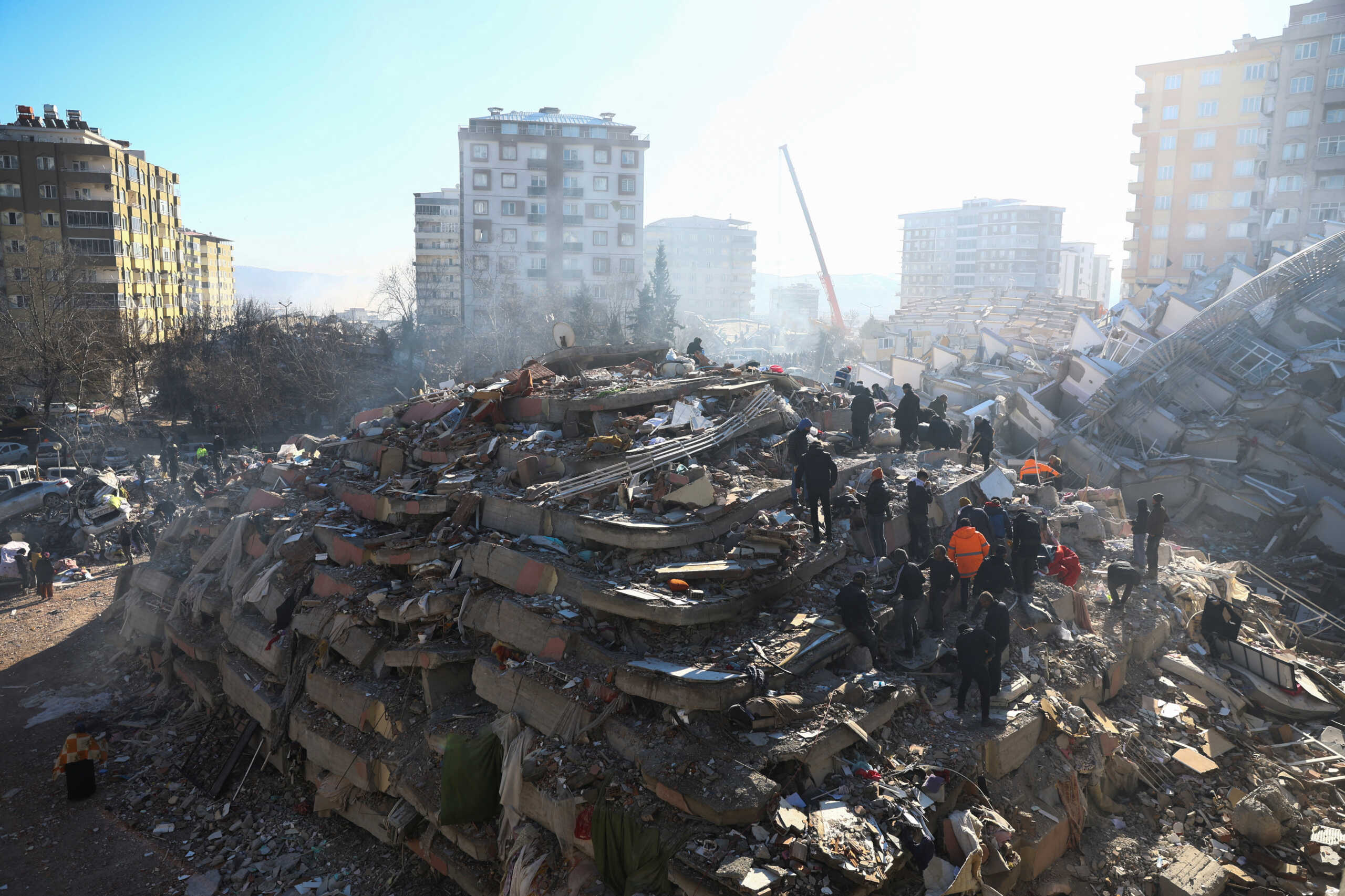 People work at the site of a collapsed building, in the aftermath of the deadly earthquake, in Kahramanmaras, Turkey, February 8, 2023. REUTERS