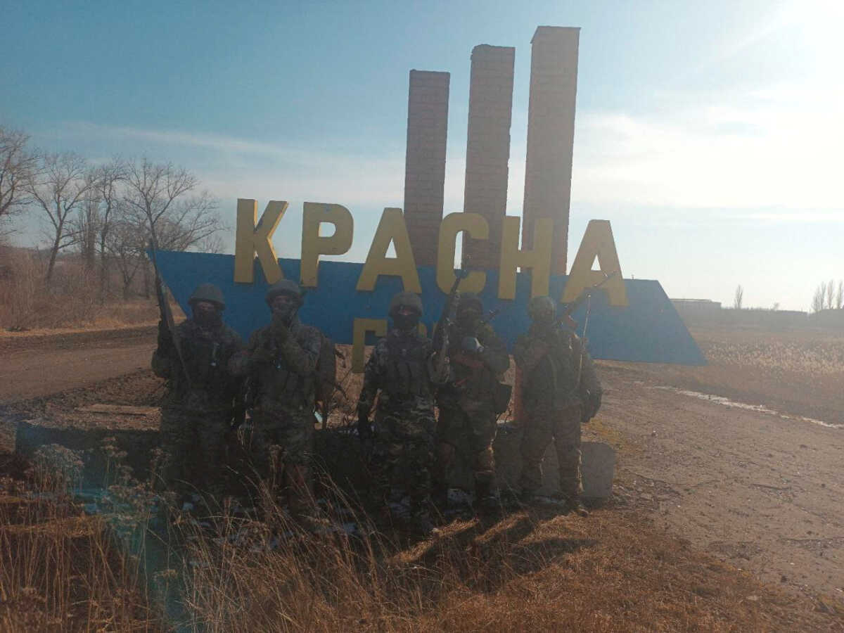 An image, released by founder of Russia's Wagner Group Yevgeny Prigozhin's press service, shows what it said to be Wagner fighters posing for a picture at the entrance sign to the village of Krasna Hora near the embattled city of Bakhmut, Ukraine, in this handout picture released February 12, 2023. Press service of "Concord"