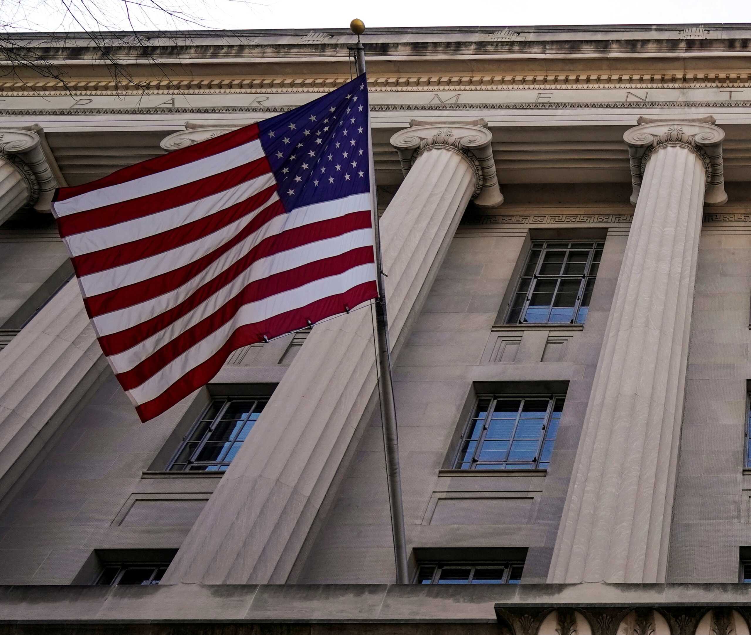 FILE PHOTO: A flag flies from the Department of Justice in Washington, U.S., March 24, 2019.      REUTERS