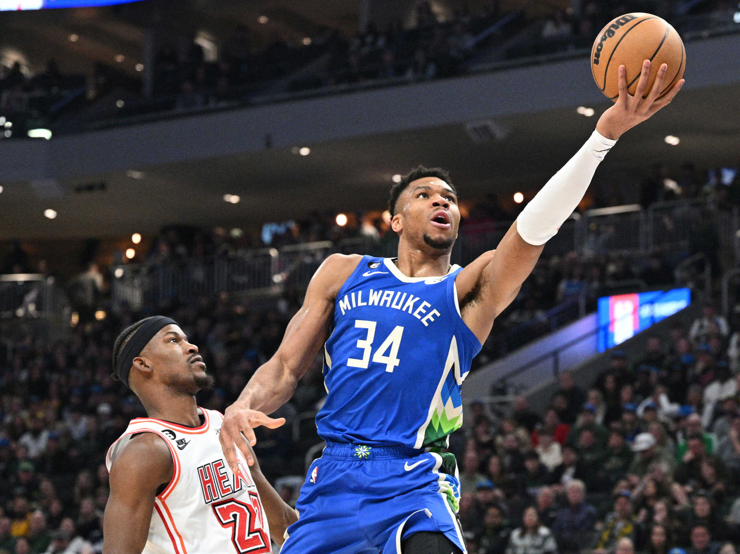 Feb 4, 2023; Milwaukee, Wisconsin, USA; Milwaukee Bucks forward Giannis Antetokounmpo (34) drives to the basket against Miami Heat forward Jimmy Butler (22) in the first half at Fiserv Forum. Mandatory Credit: Michael McLoone-USA TODAY Sports