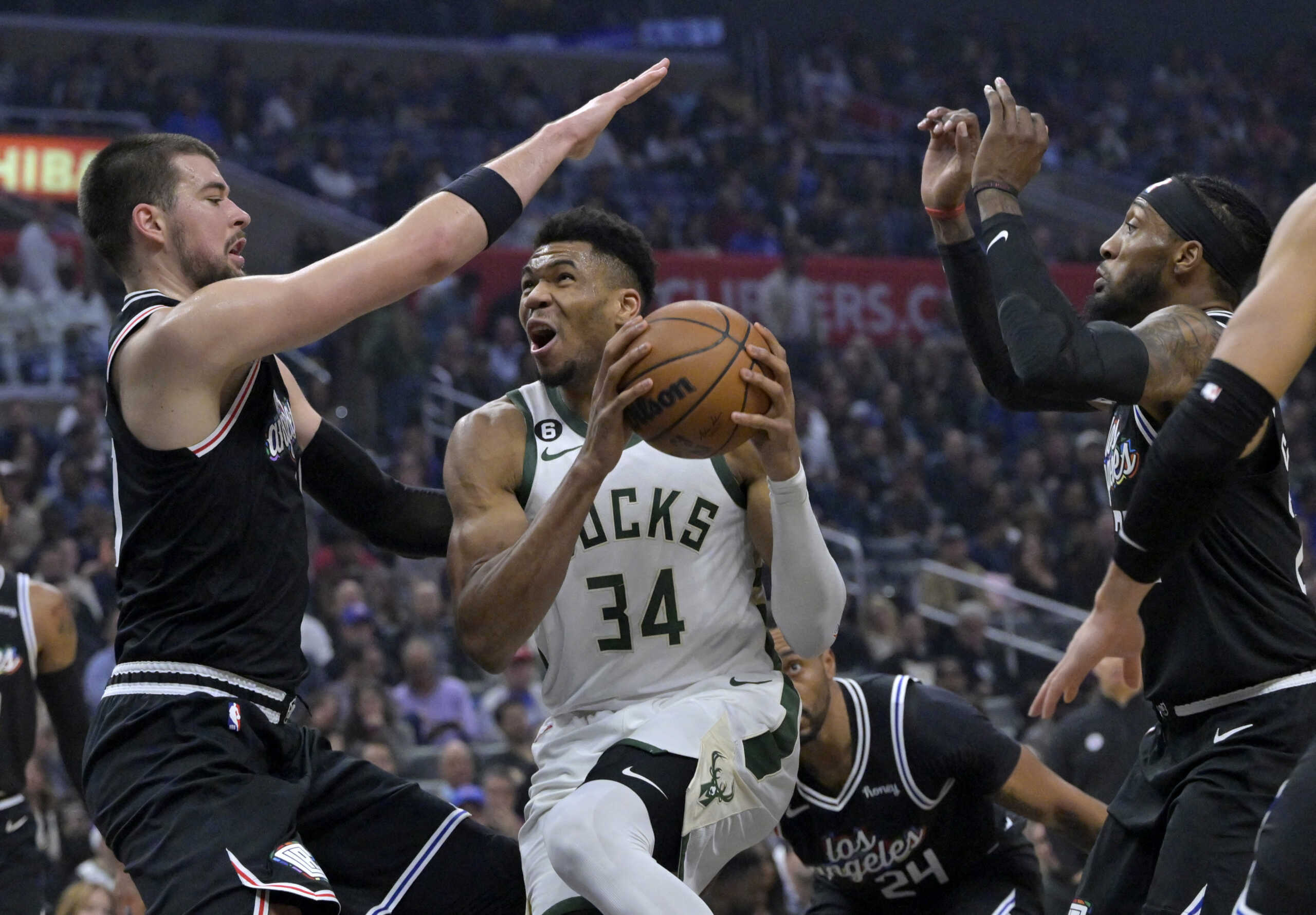 Feb 10, 2023; Los Angeles, California, USA;  Milwaukee Bucks forward Giannis Antetokounmpo (34) drives past Los Angeles Clippers center Ivica Zubac (40) and forward Robert Covington (23) for a basket in the first half at Crypto.com Arena. Mandatory Credit: Jayne Kamin-Oncea-USA TODAY Sports