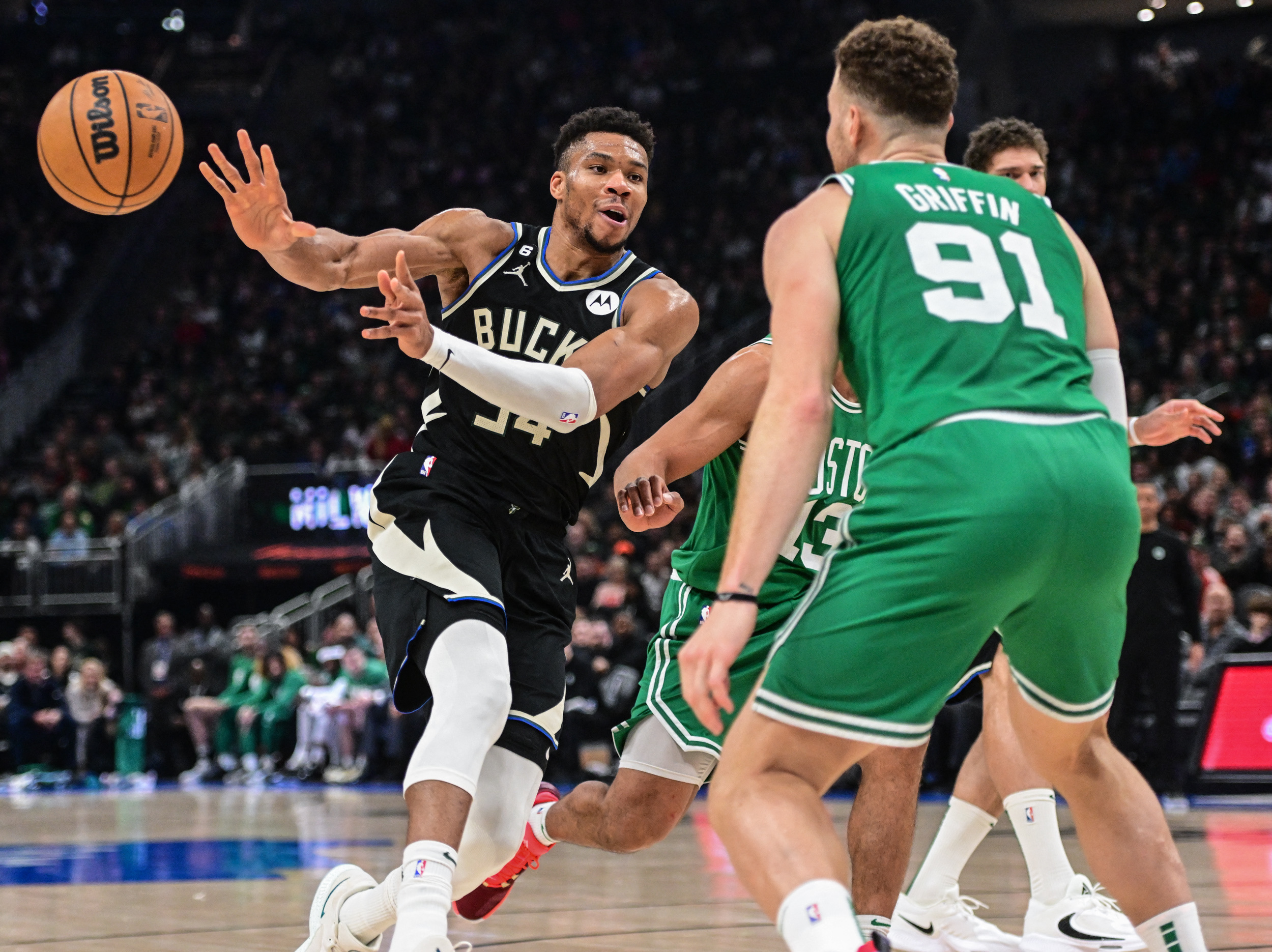 Feb 14, 2023; Milwaukee, Wisconsin, USA;  Milwaukee Bucks forward Giannis Antetokounmpo (34) passes against Boston Celtics forward Blake Griffin (91) in the second quarter at Fiserv Forum. Mandatory Credit: Benny Sieu-USA TODAY Sports
