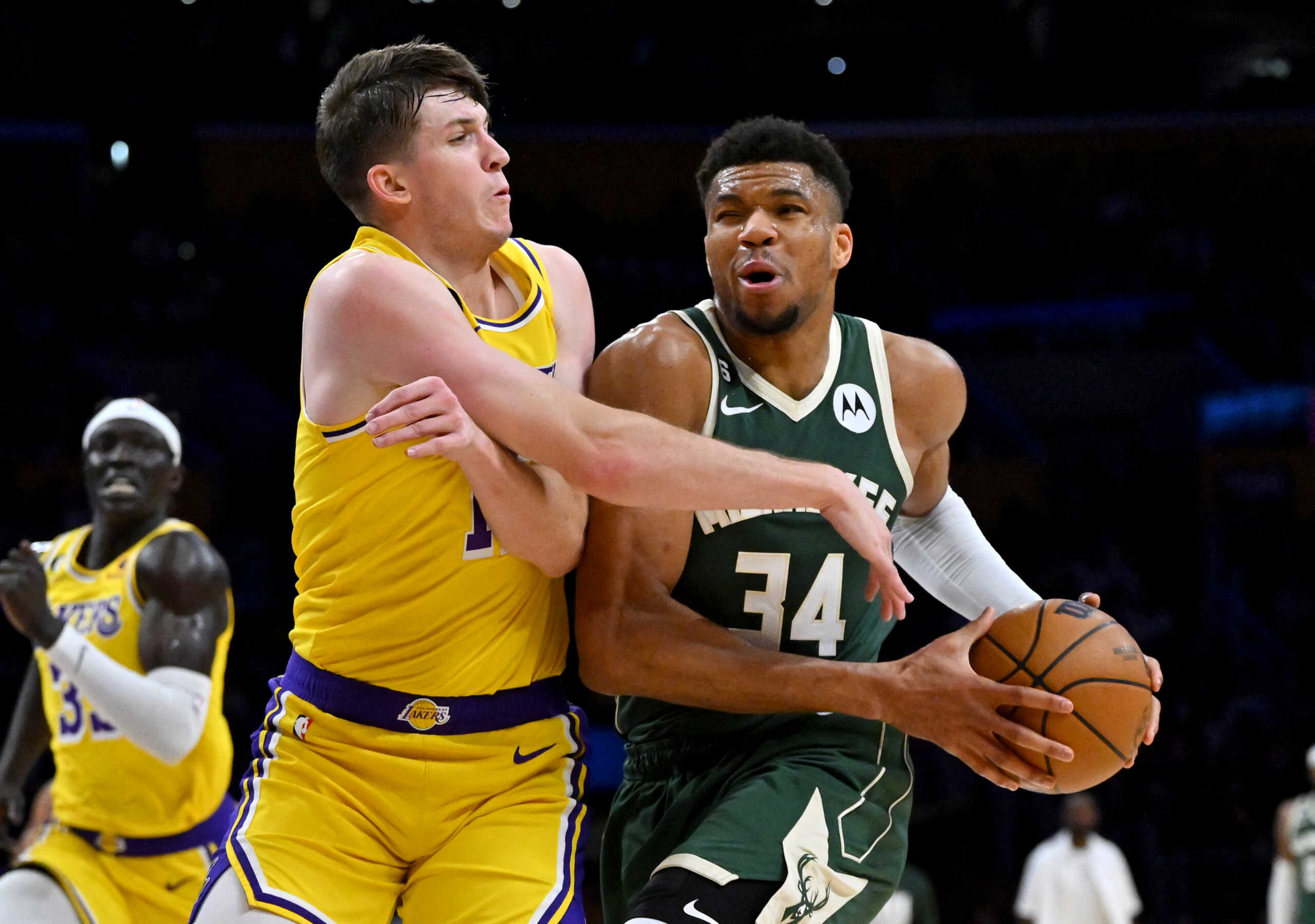 Feb 9, 2023; Los Angeles, California, USA;  Los Angeles Lakers guard Austin Reaves (15) defends Milwaukee Bucks forward Giannis Antetokounmpo (34) as he drives to the basket in the first half at Crypto.com Arena. Mandatory Credit: Jayne Kamin-Oncea-USA TODAY Sports