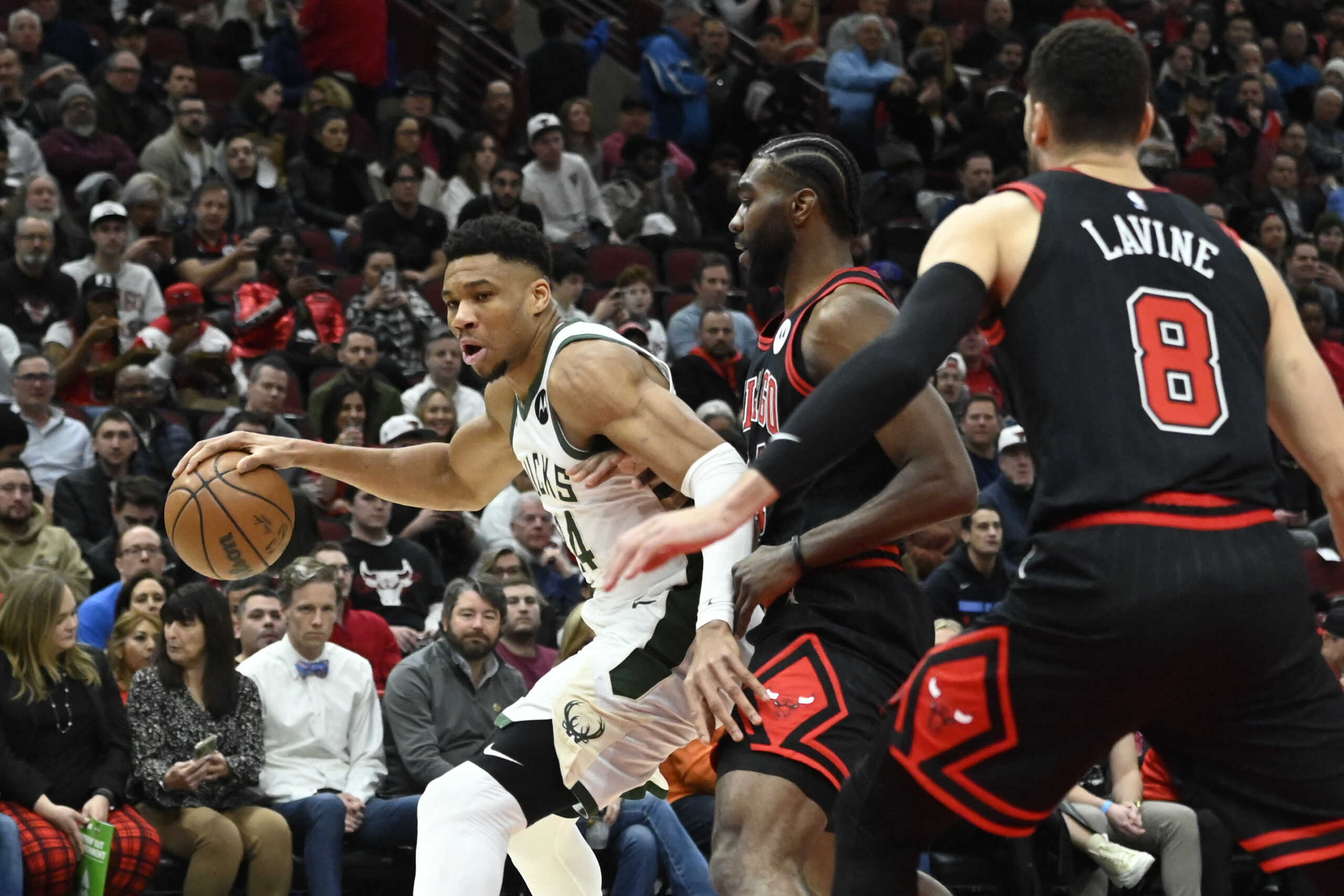 Feb 16, 2023; Chicago, Illinois, USA;  Milwaukee Bucks forward Giannis Antetokounmpo (34) dribbles against Chicago Bulls forward Patrick Williams (44), and Chicago Bulls guard Zach LaVine (8) during the first half at the United Center. Mandatory Credit: Matt Marton-USA TODAY Sports