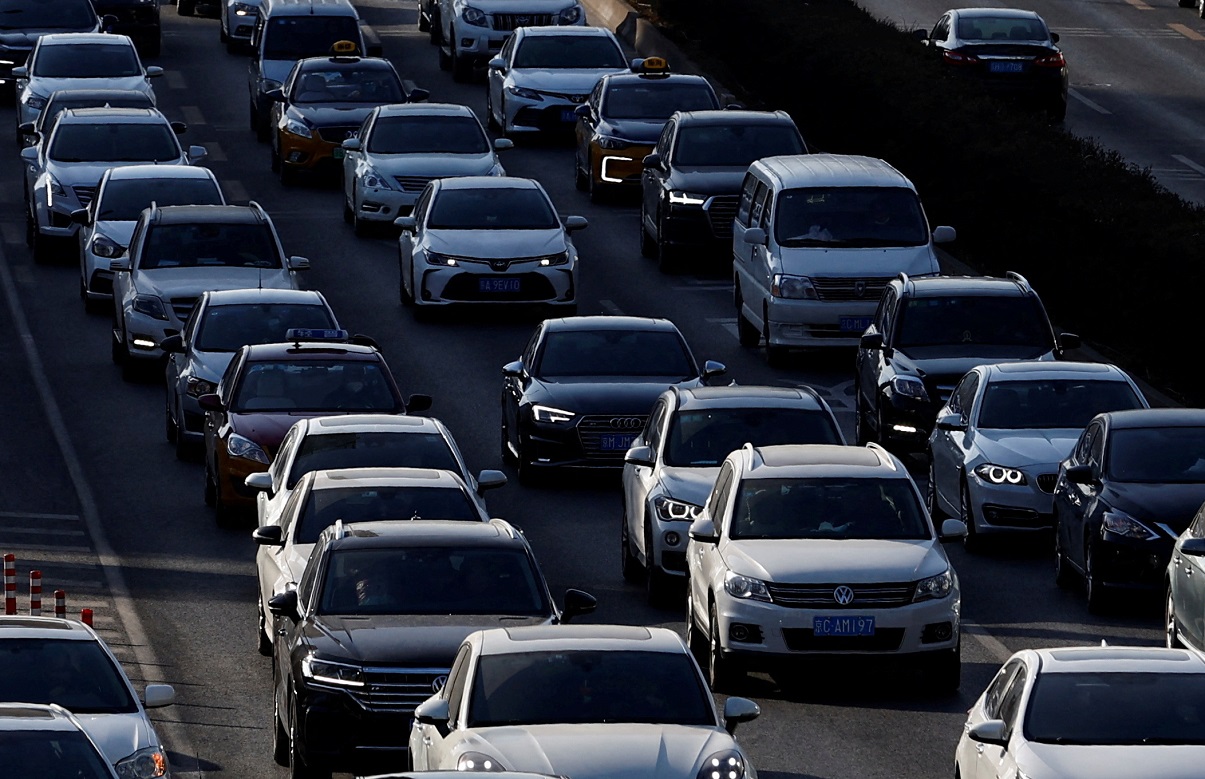 FILE PHOTO: Cars move on a street at the Beijing's Central Business District (CBD), during the morning rush hour following the Chinese Lunar New Year holiday, in Beijing, China, January 30, 2023. REUTERS