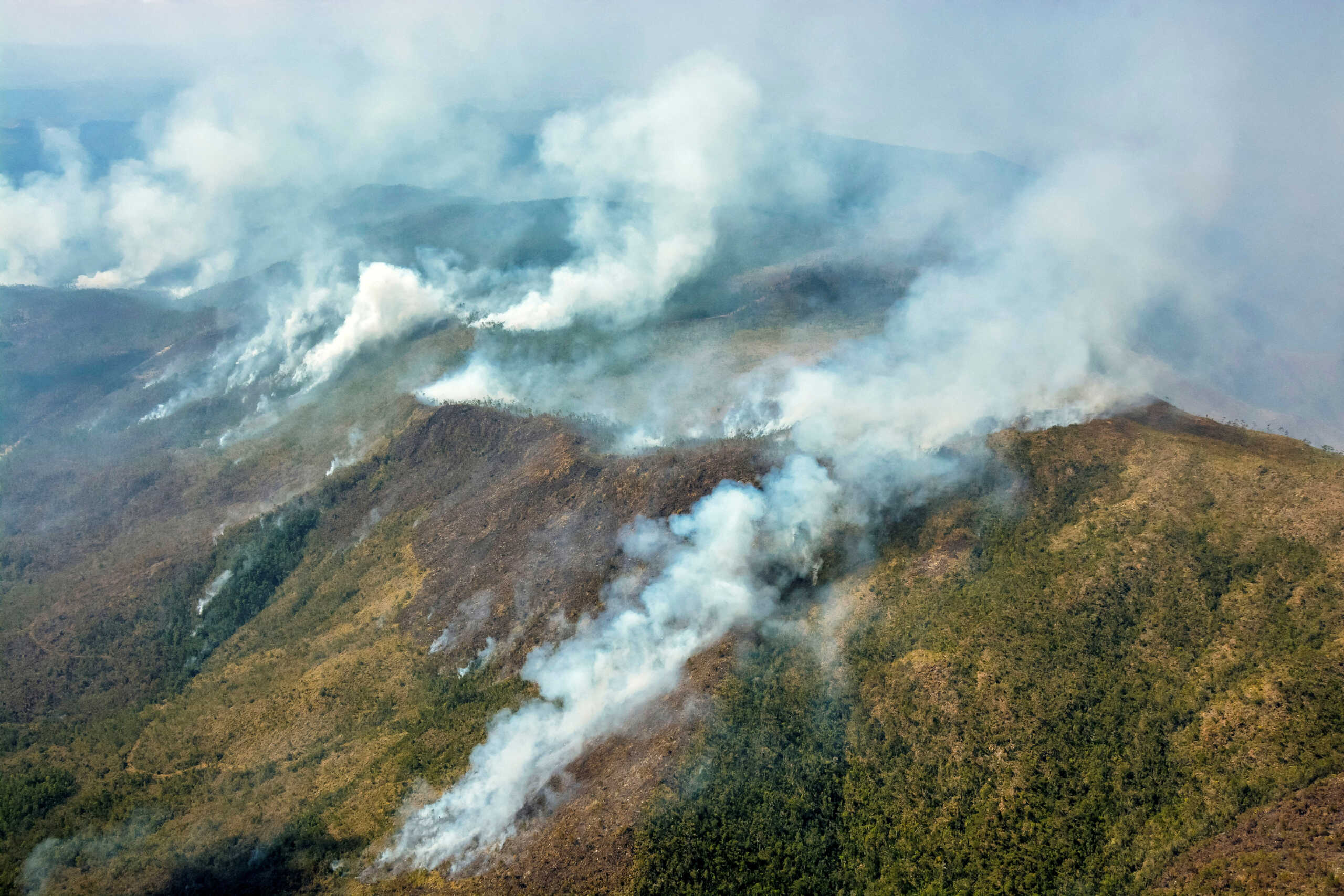 Smoke from burning vegetation rises in Pinares de Mayari, Cuba, February 23, 2023. REUTERS