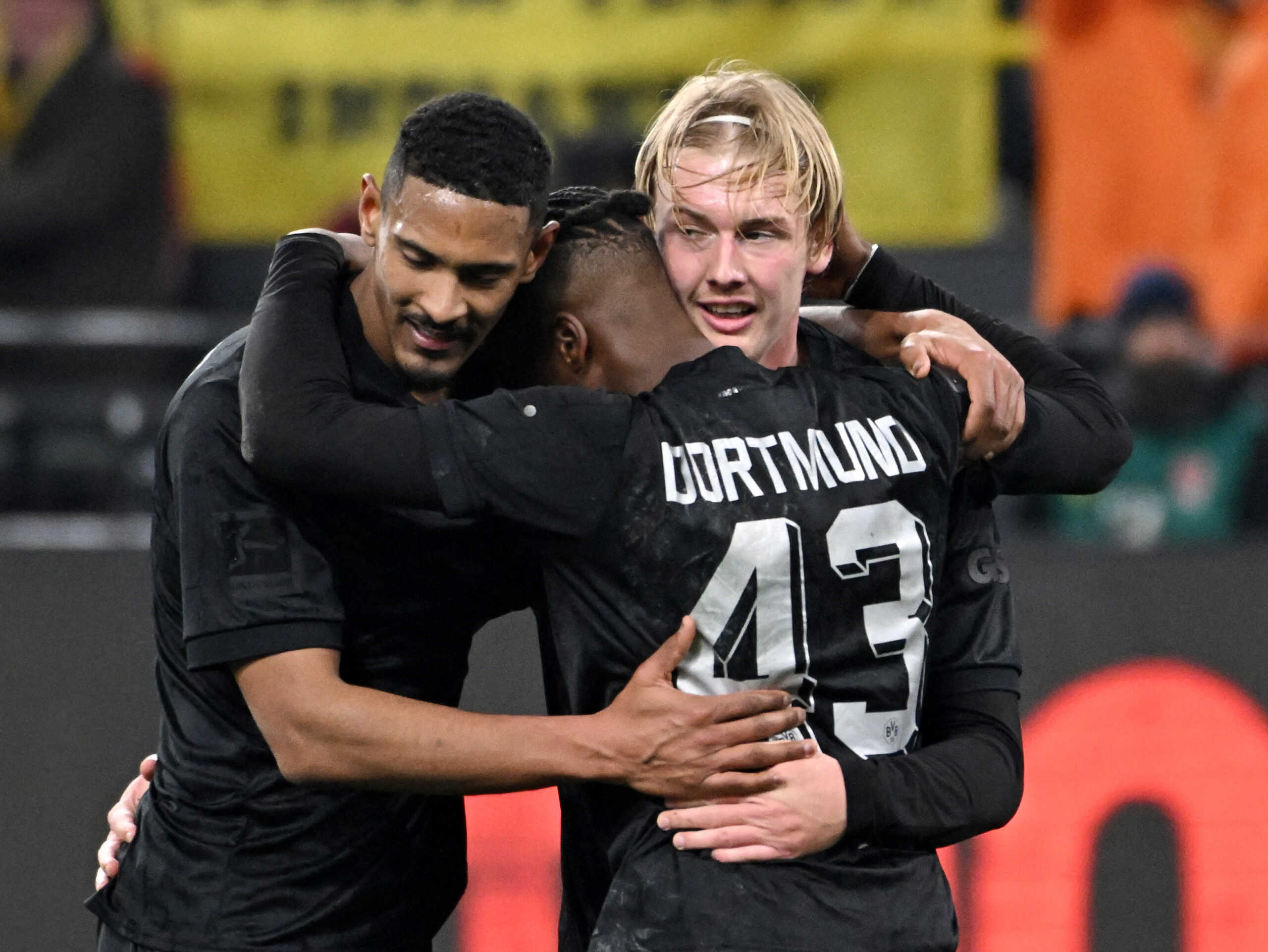 Soccer Football - Bundesliga - Borussia Dortmund v Hertha BSC - Signal Iduna Park, Dortmund, Germany - February 19, 2023 Borussia Dortmund's Julian Brandt celebrates scoring their fourth goal with Sebastien Haller and Jamie Bynoe-Gittens REUTERS