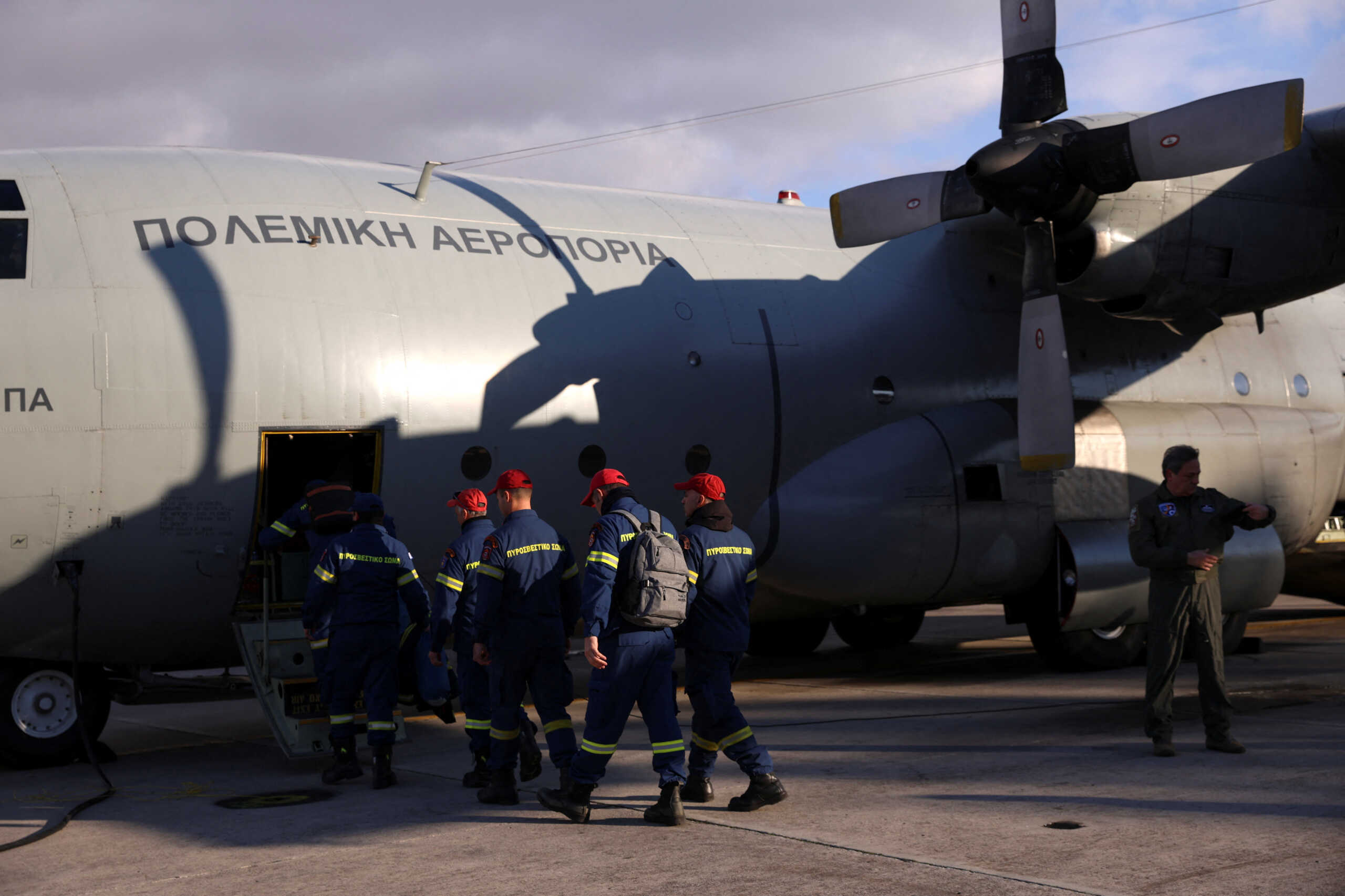 Members of the Disaster Response Special Unit who will fly to Turkey to help in the aftermath of an earthquake, board a Hellenic Air Force C-130, before departing from the military airport of Elefsina, Greece, February 6, 2023. REUTERS