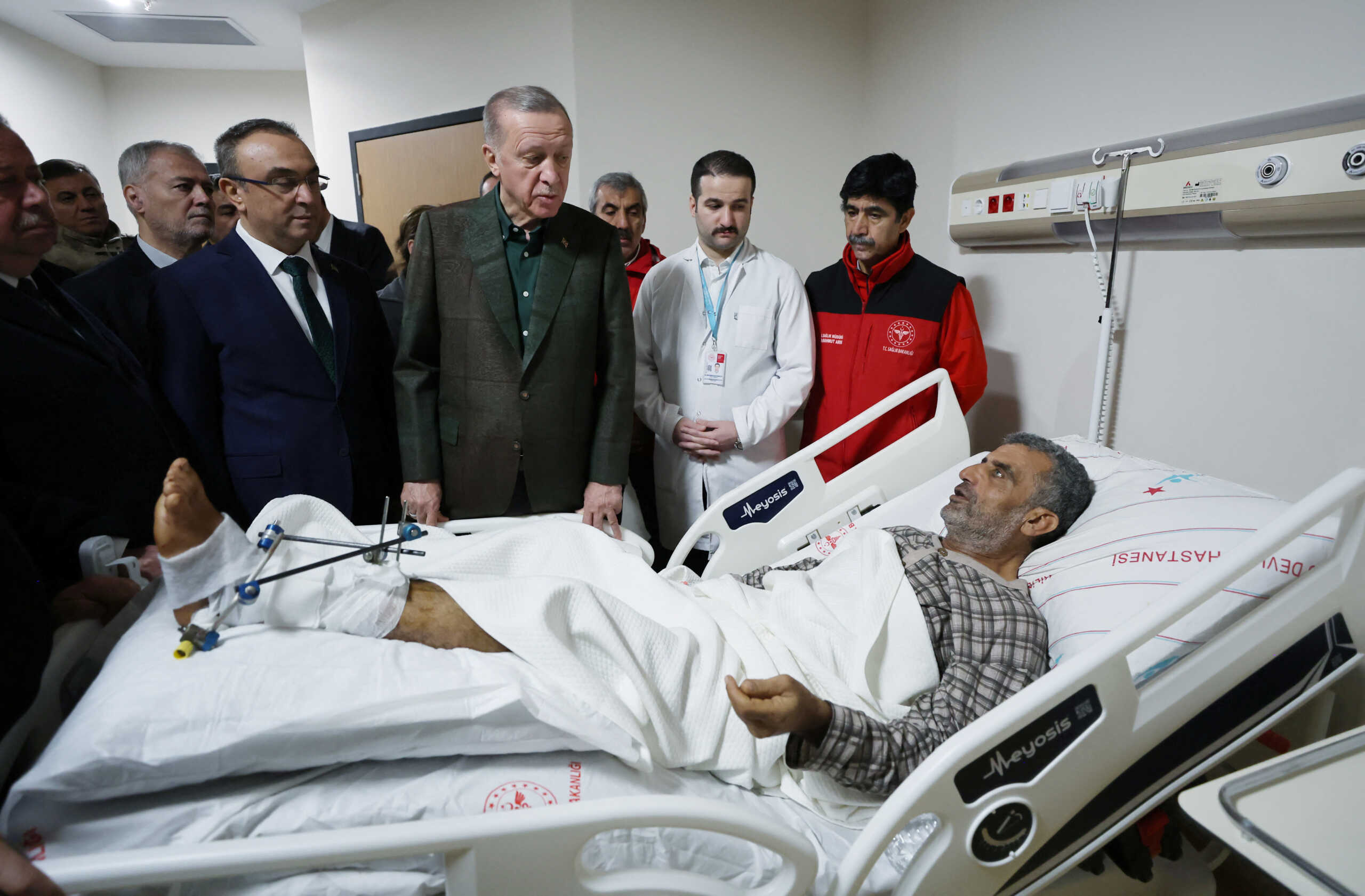 Turkish President Tayyip Erdogan visits a survivor at a hospital in the aftermath of a deadly earthquake in Kilis, Turkey February 9, 2023. Murat Cetinmuhurdar