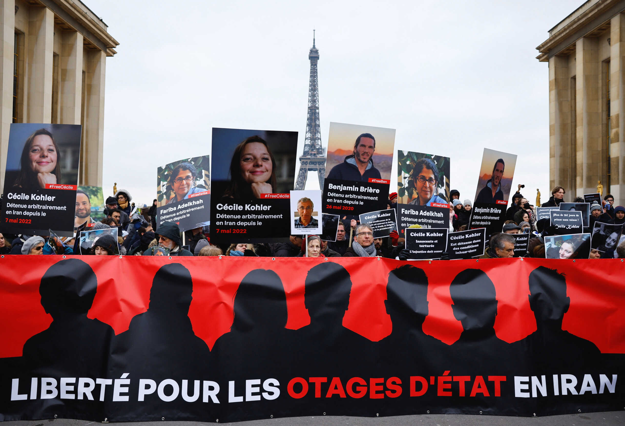 Supporters and relatives of French citizens detained in Iran, Cecile Kohler, Benjamin Briere, Jacques Paris and Fariba Adelkhah, gather in front of the Eiffel Tower, during a rally demanding their release, in Paris, France, January 28, 2023.   REUTERS