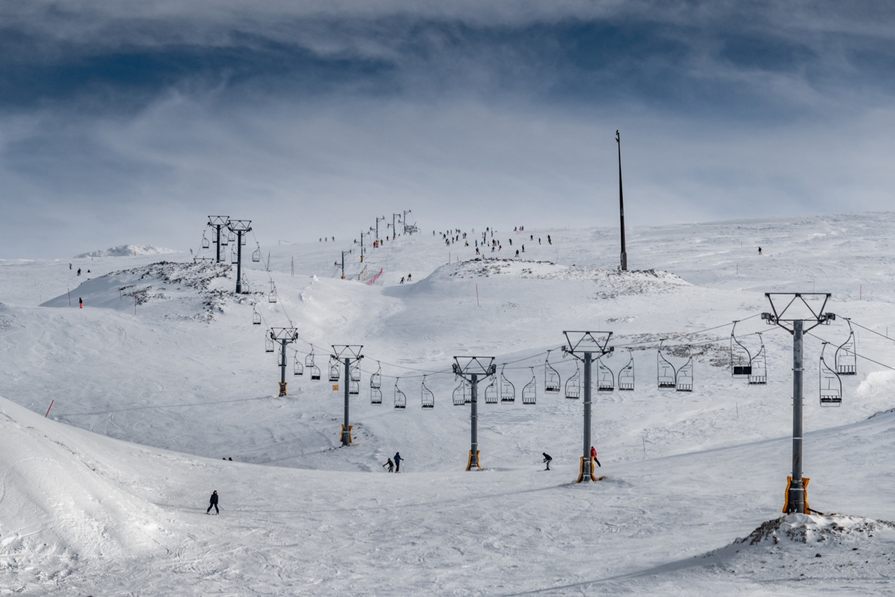 The famous snowed mountain of Parnassos with popular ski resort covered up in snow and unique nature, cable cabins, Voiotia, Greece