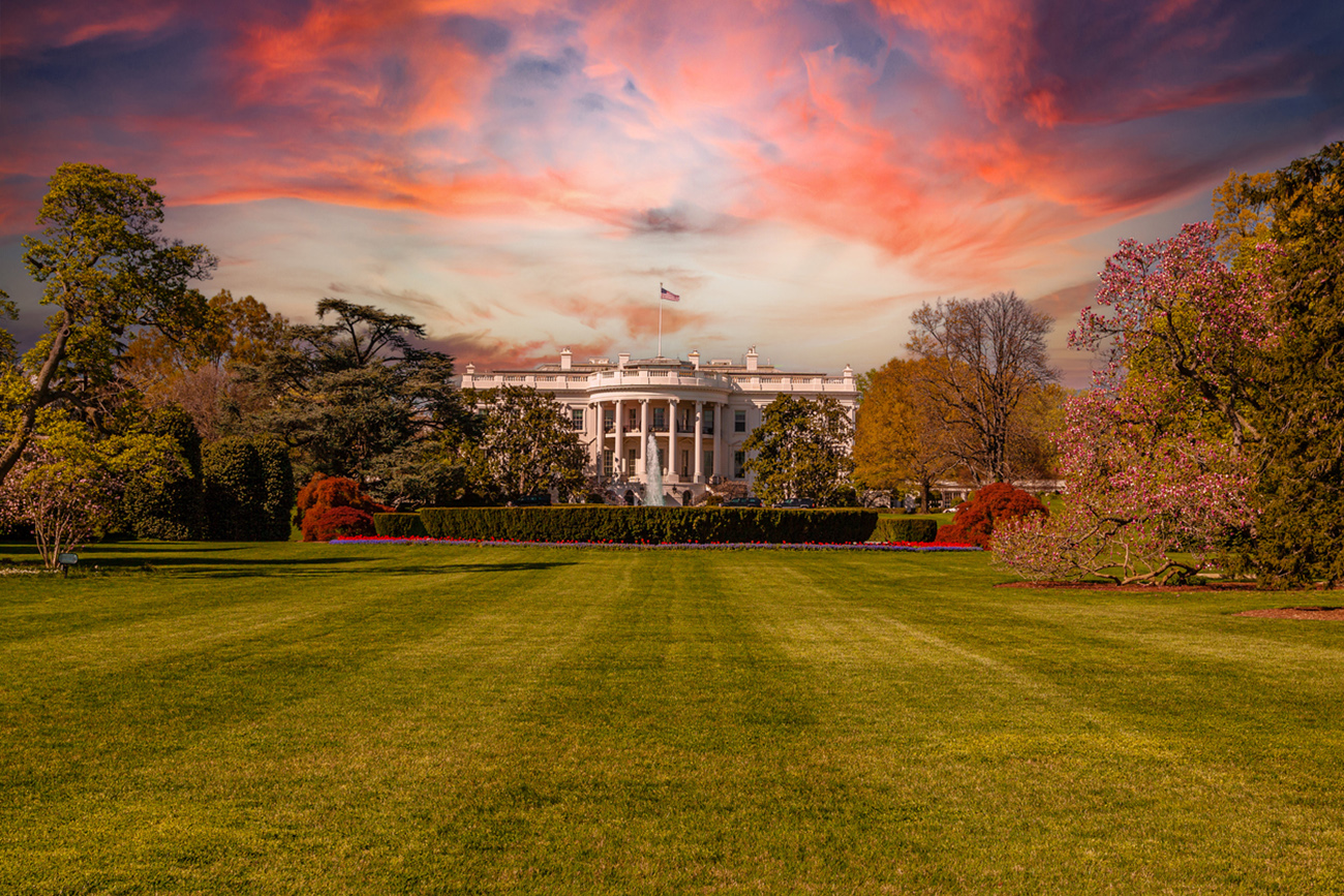 White House in the Spring with Green Grass, Trees, Red Tulips, Fountain, Black SUV and Blue, Orange and Yellow Dramatic Sunset Sky with Puffy Clouds, Lit by the Early Evening Sun, Washington DC, USA. Canon EF 24-105mm f