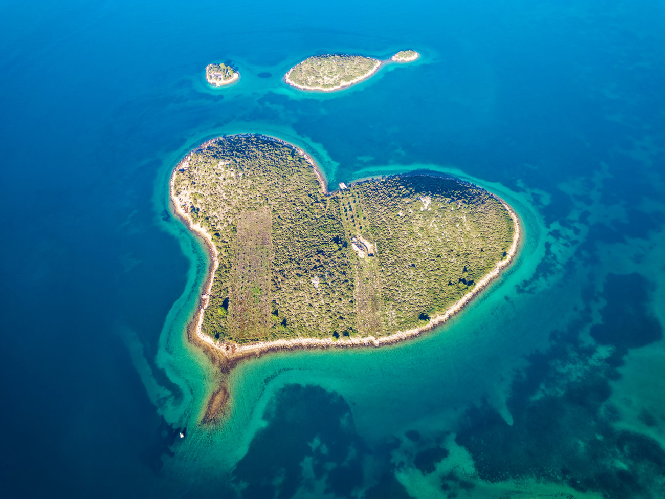 Aerial drone view of Galesnjak the Island of Love in Croatia with beautiful blue turquoise sea water. Heart shaped Island. Travel and holidays destination. Amazing tourism in Croatia Islands.