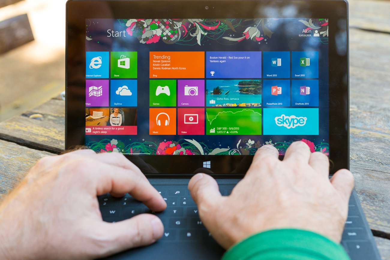 Ankara, Turkey - September 8, 2013:  Man using his surface tablet at the park. Microsoft Surface is a series of tablets designed and marketed by Microsoft