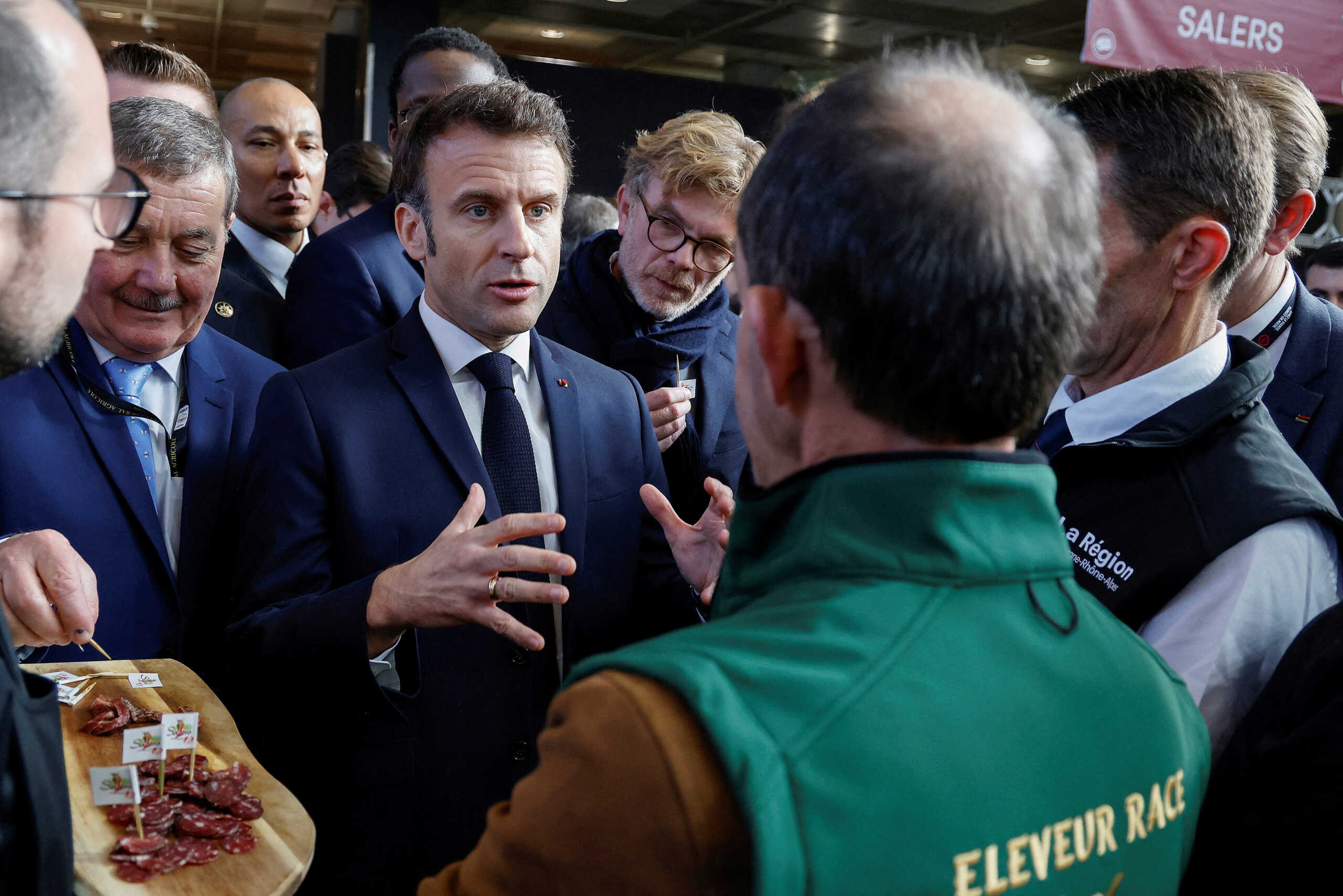 France's President Emmanuel Macron talks to a breeder, on the inauguration day of the 59th edition of the Agriculture fair in Paris, France February 25, 2023.  Ludovic Marin