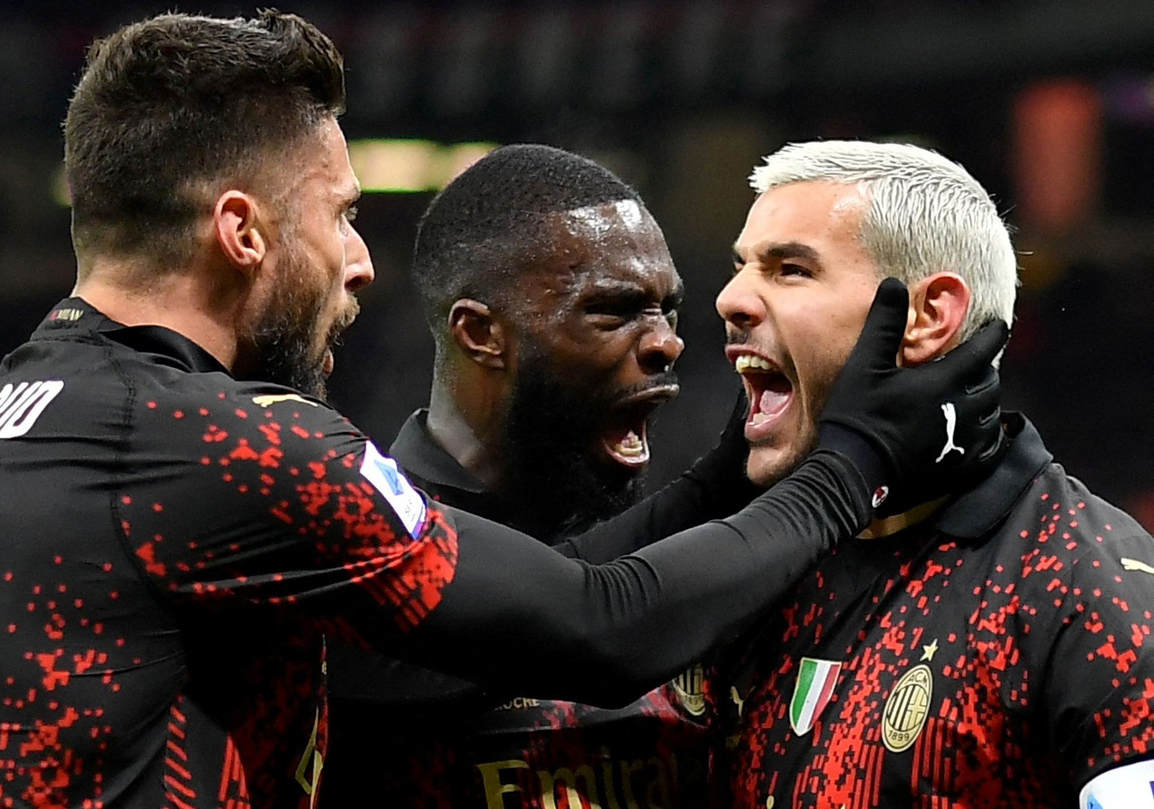 Soccer Football - Serie A - AC Milan v Atalanta - San Siro, Milan, Italy - February 26, 2023 AC Milan's Theo Hernandez celebrates with Olivia Giroud and Fikayo Tomori after Atalanta's Juan Musso scores an own goal and AC Milan's first goal REUTERS