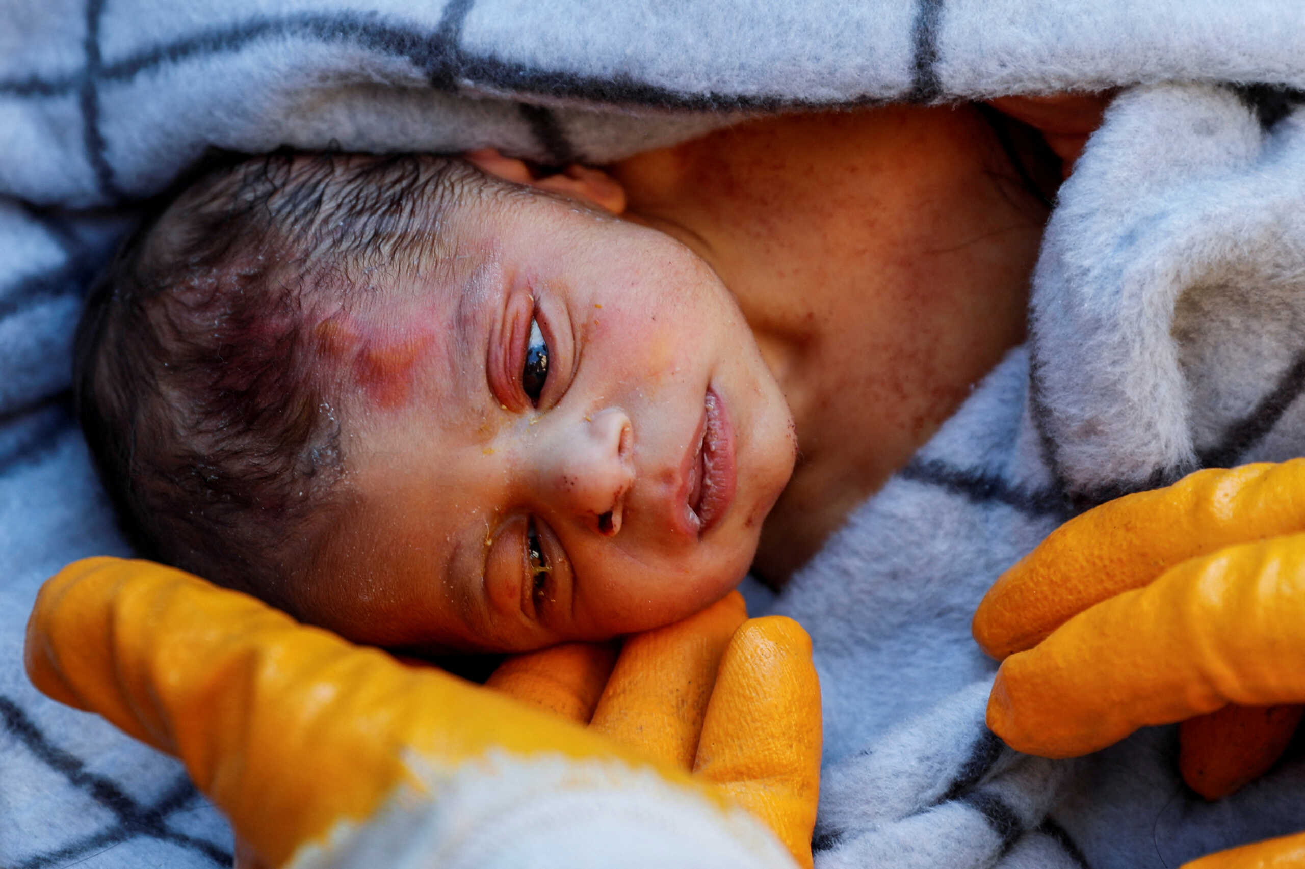 A rescuer holds baby boy Kerem Agirtas, a 20-day-old survivor who was pulled from under the rubble, in the aftermath of a deadly earthquake in Hatay, Turkey, February 8, 2023. REUTERS