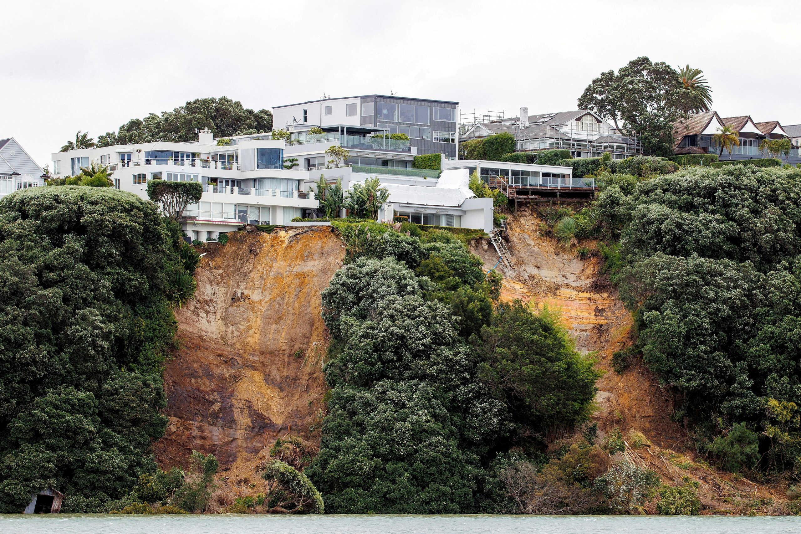 FILE PHOTO: A view of a slip near a house on a clifftop caused by continuous bad weather as Cyclone Gabrielle approaches in Auckland, New Zealand, February 12, 2023. AAP Image