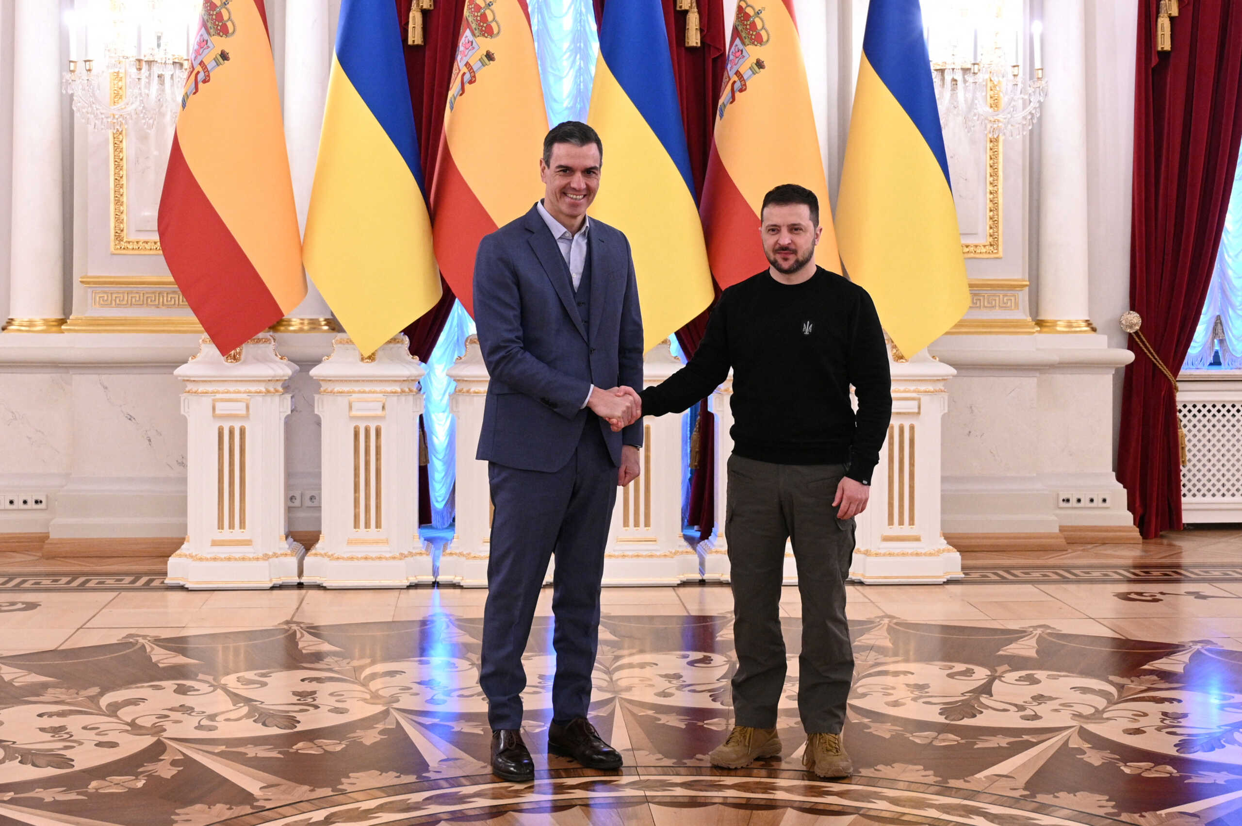 Ukraine's President Volodymyr Zelenskiy and Spain's Prime Minister Pedro Sanchez shake hands during a meeting, amid Russia's attack on Ukraine, in Kyiv, Ukraine February 23, 2023. Moncloa Palace
