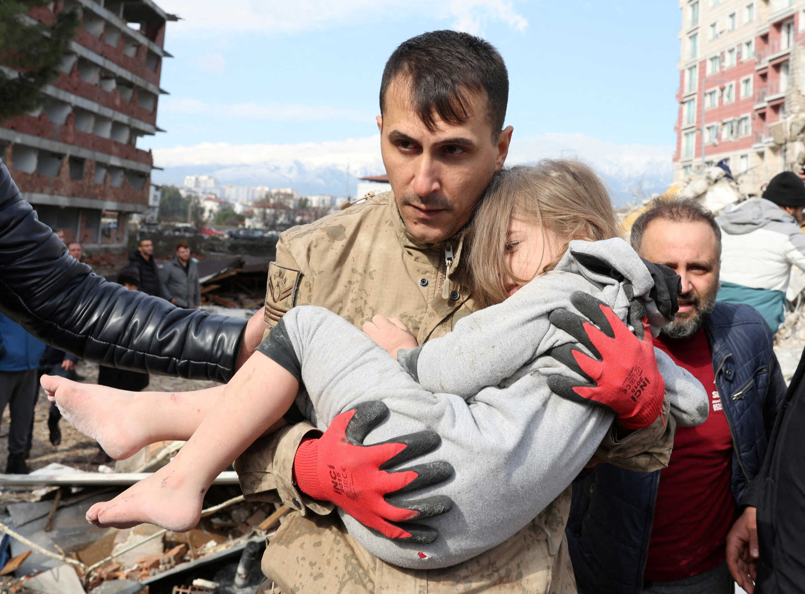 FILE PHOTO: Muhammet Ruzgar, 5, is carried out by a rescuer from the site of a damaged building, following an earthquake in Hatay, Turkey, February 7, 2023. REUTERS
