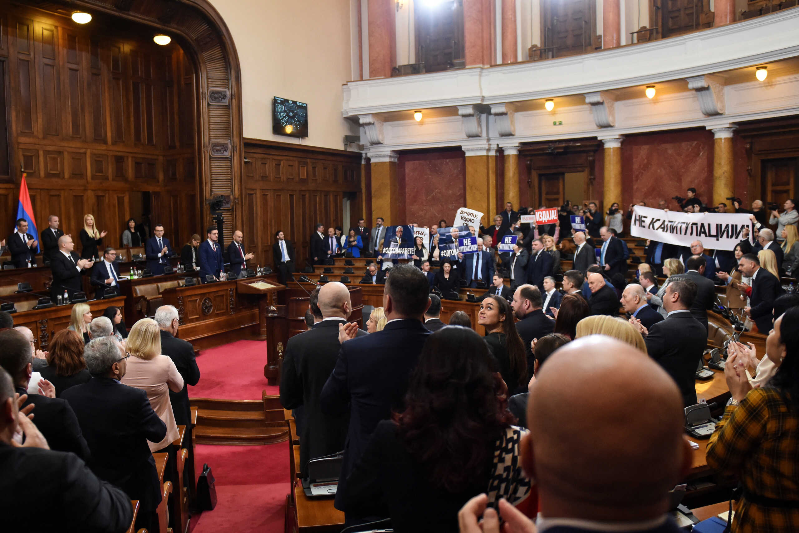 Lawmakers hold pictures of assassinated Kosovo Serb politician Oliver Ivanovic and banners that read: "Not to the ultimatum!" and "Vucic, betrayed Kosovo", during a special session of Serbia's parliament about the negotiating process with Kosovo in Belgrade, Serbia, February 2, 2023. REUTERS