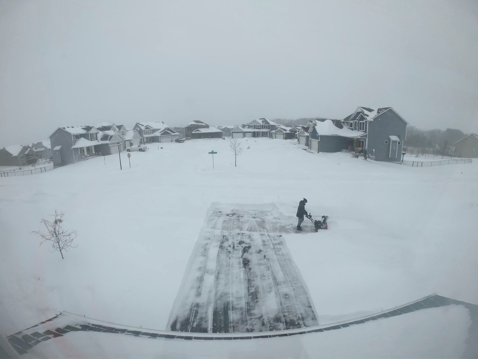 A person clears snow during a winter storm in Forest Lake, Minnesota, U.S. in this still image obtained from a social media time-lapse video taken February 21, 2023- February 23, 2023.  Chris Kieger