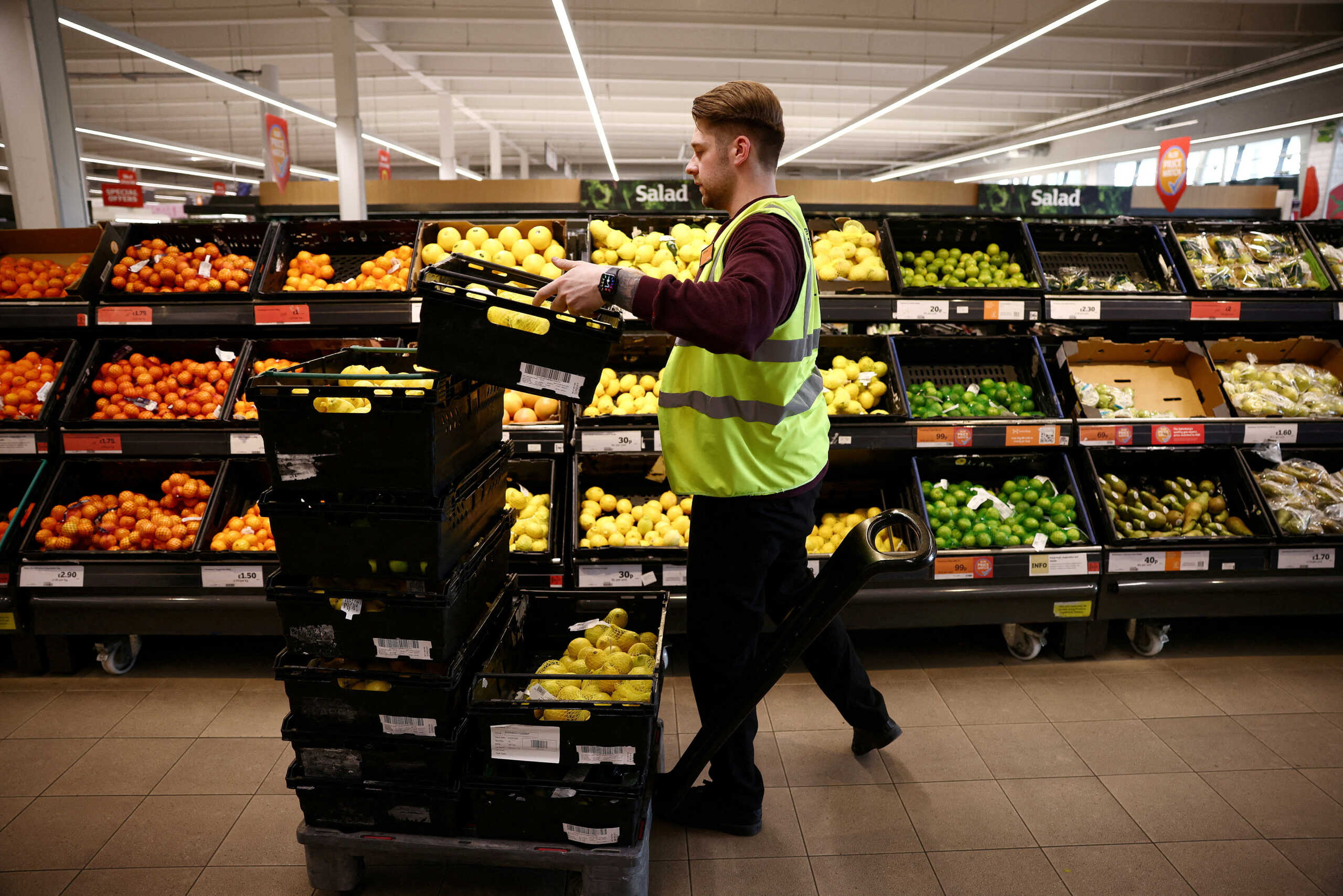 FILE PHOTO: A employee arranges produce inside a Sainsbury?s supermarket in Richmond, west London, Britain, June 27, 2022. Picture taken June 27, 2022. REUTERS