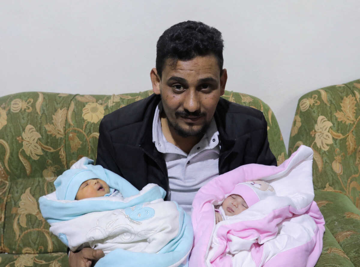 Khalil Al-Sawadi, the uncle-by-marriage of a baby girl born during a deadly earthquake earlier this month, holds her and his own newborn daughter, in Jandaris, Syria February 18, 2023.  REUTERS