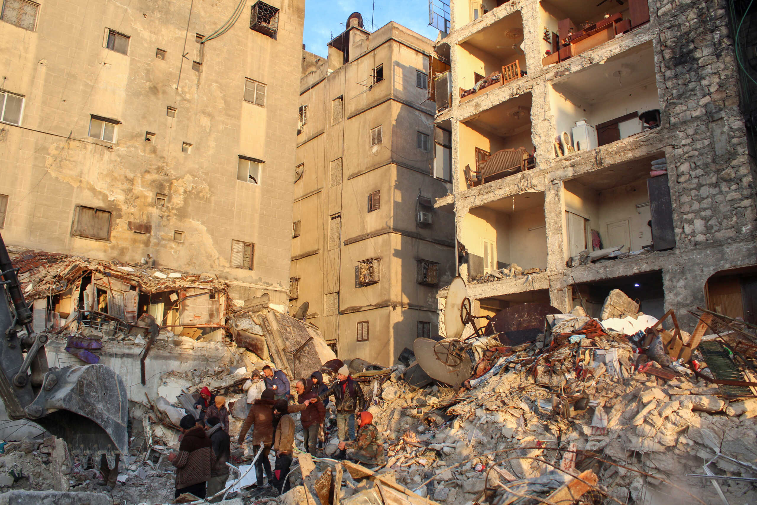 People gather on the rubble as the search for survivors continues, in the aftermath of the earthquake, in Aleppo, Syria February 7, 2023. REUTERS