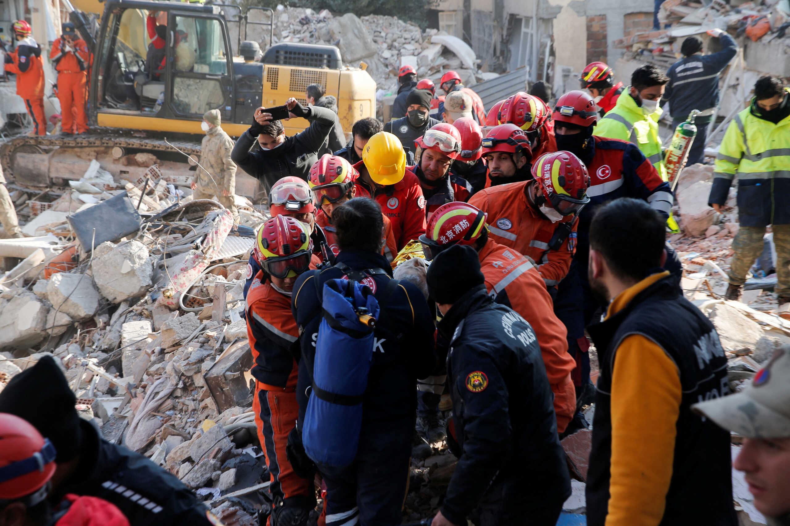 Turkish and Chinese rescuers carry Malek, a 55-year-old Syrian refugee man, into an ambulance after he was rescued from the wreckage of a destroyed building in the aftermath of the deadly earthquake in Hatay, Turkey February 12, 2023. REUTERS