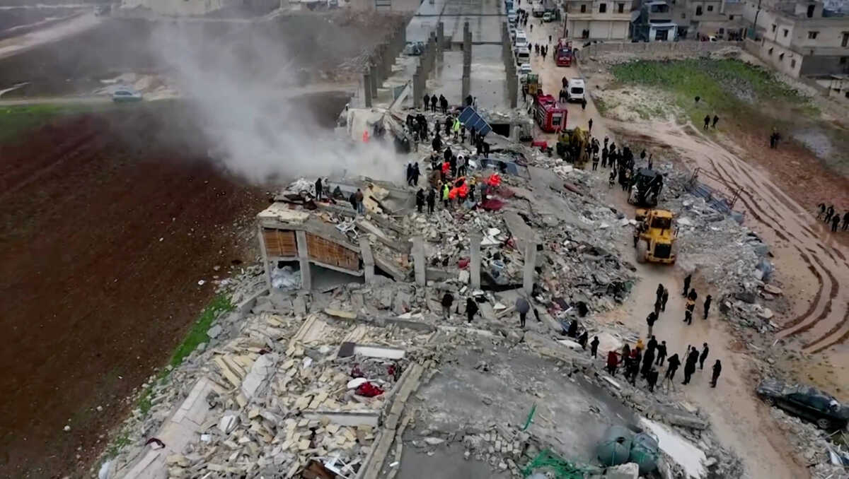 Rescuers search through rubble of collapsed buildings following an earthquake, in the rebel-held town of Sarmada, Syria February 6, 2023 in this still image obtained from a drone footage.  WHITE HELMETS