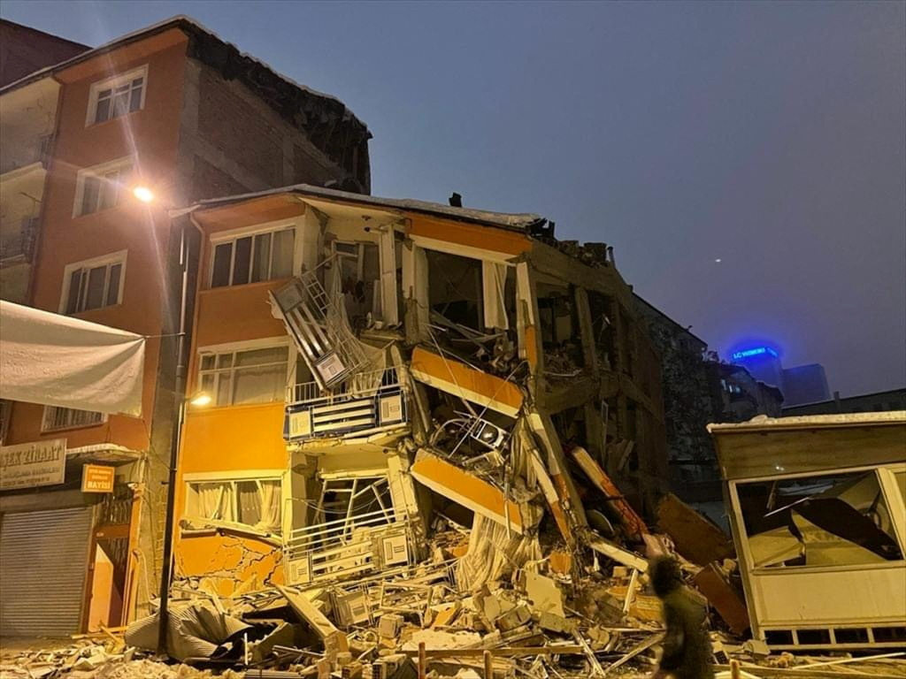 A man walks past by a collapsed building after an earthquake in Malatya, Turkey February 6, 2023. Depo Photos via REUTERS ATTENTION EDITORS - THIS PICTURE WAS PROVIDED BY A THIRD PARTY. NO RESALES. NO ARCHIVES. TURKEY OUT. NO COMMERCIAL OR EDITORIAL SALES IN TURKEY.