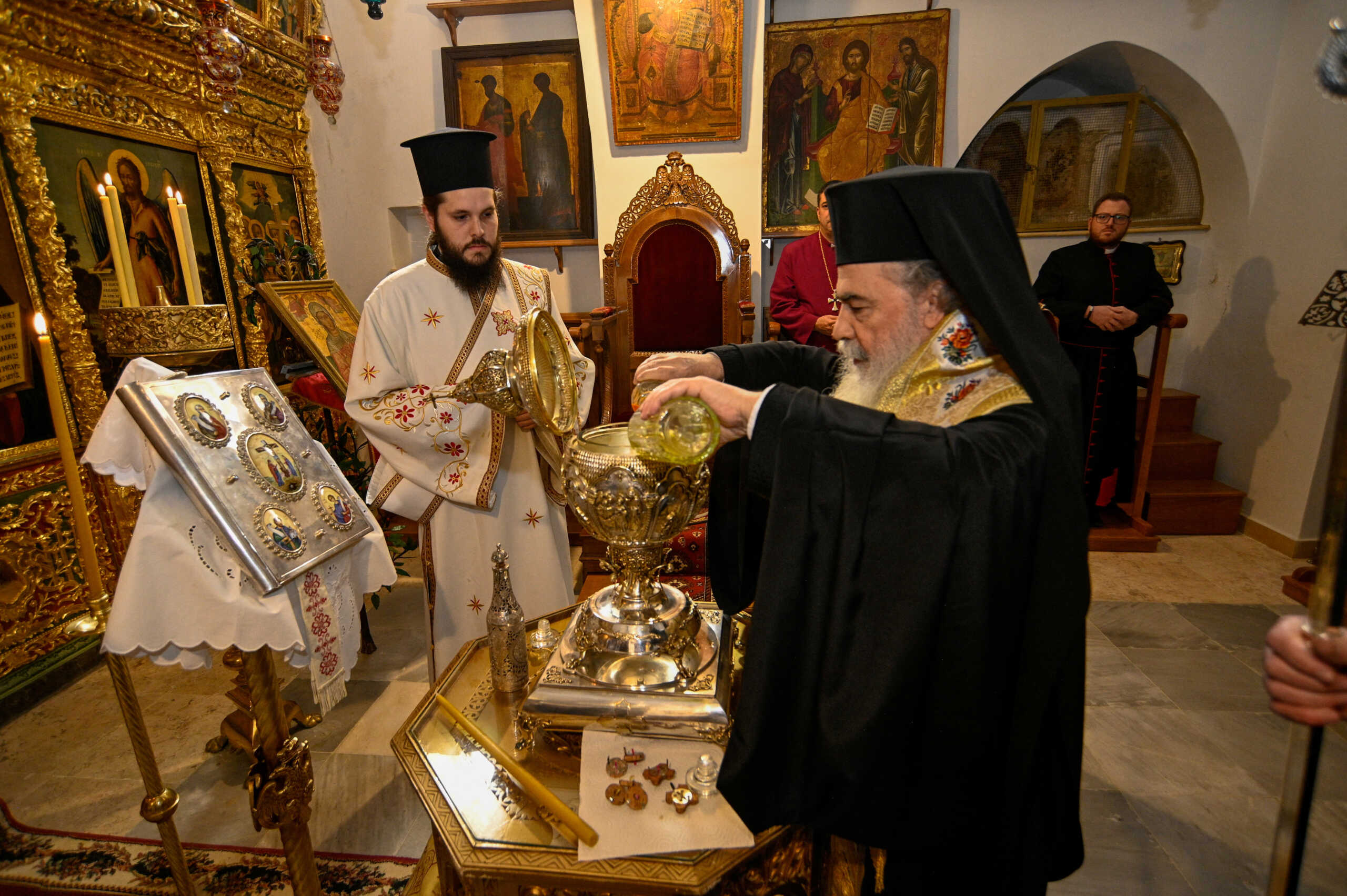 Greek Orthodox Patriarch of Jerusalem Theophilos III mixes the oils from the Mount of Olives to make Chrism Oil, which will be used in the coronation of Britain's King Charles on May 6, in Jerusalem, March 3, 2023. Patriarchate of Jerusalem