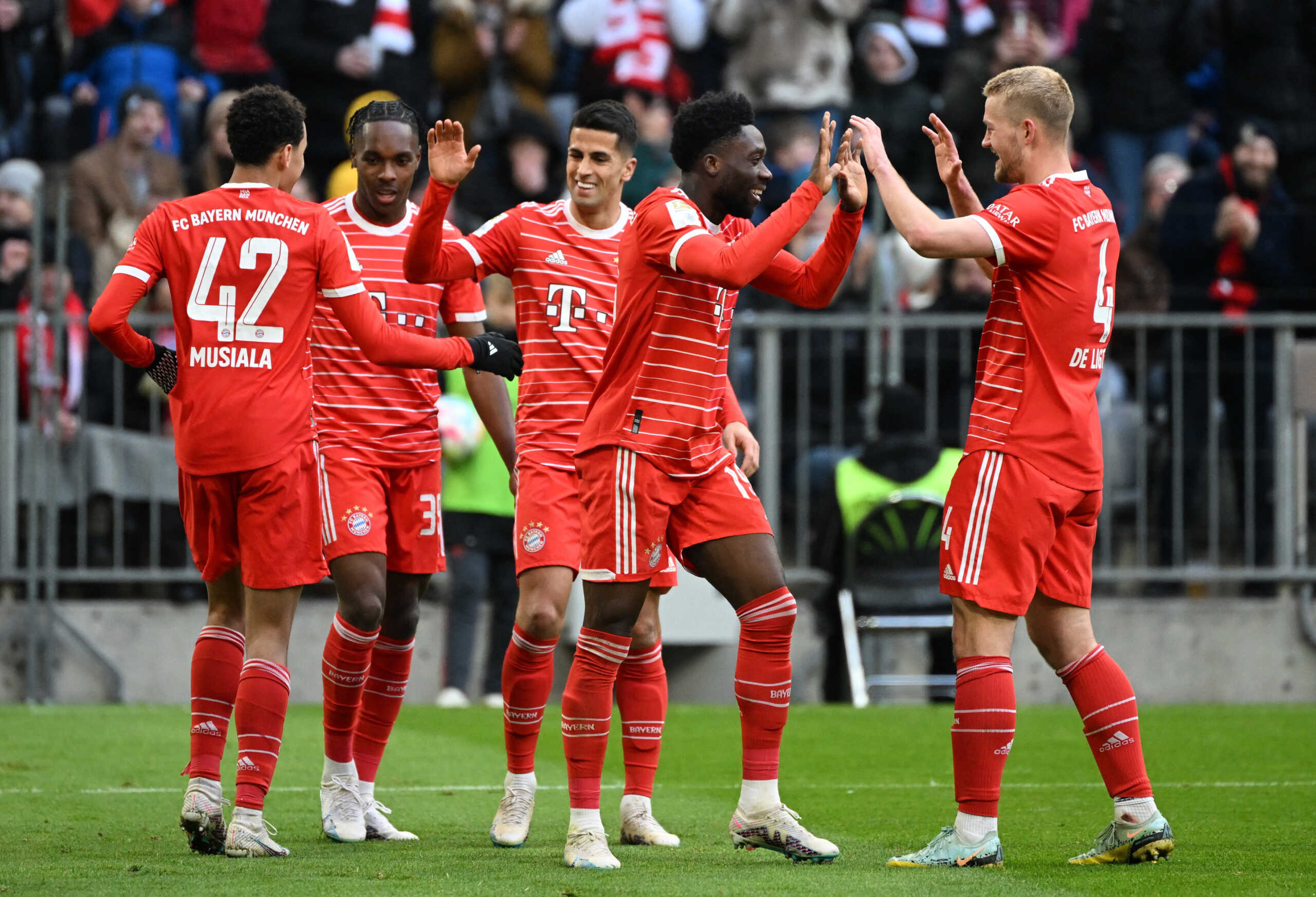 Soccer Football - Bundesliga - Bayern Munich v FC Augsburg - Allianz Arena, Munich, Germany - March 11, 2023 Bayern Munich's Alphonso Davies celebrates scoring their fifth goal with Matthijs de Ligt REUTERS