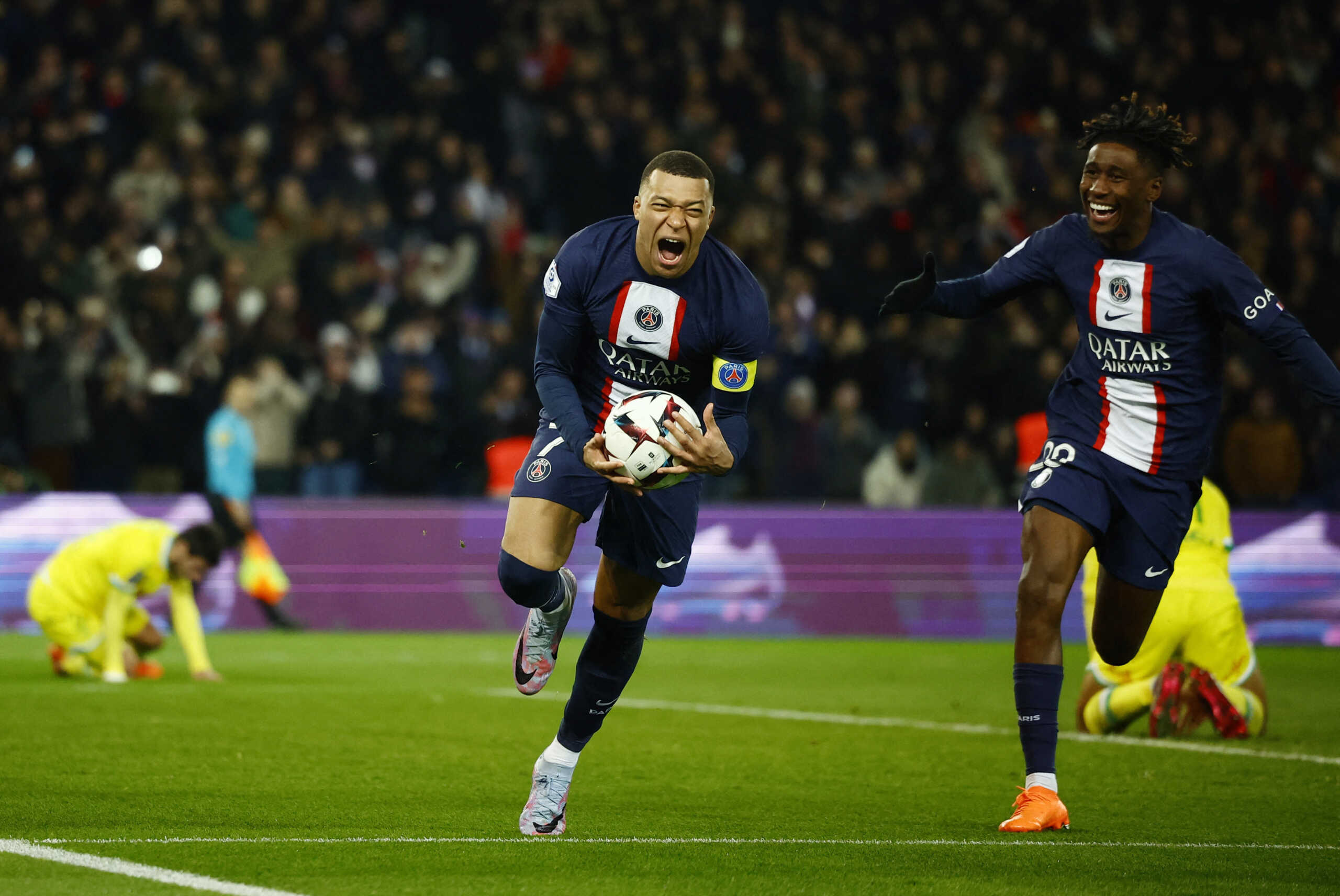 Soccer Football - Ligue 1 - Paris St Germain v Nantes - Parc des Princes, Paris, France - March 4, 2023  Paris St Germain's Kylian Mbappe celebrates scoring their fourth goal with Timothee Pembele and becomes Paris St Germain's all time top goalscorer REUTERS