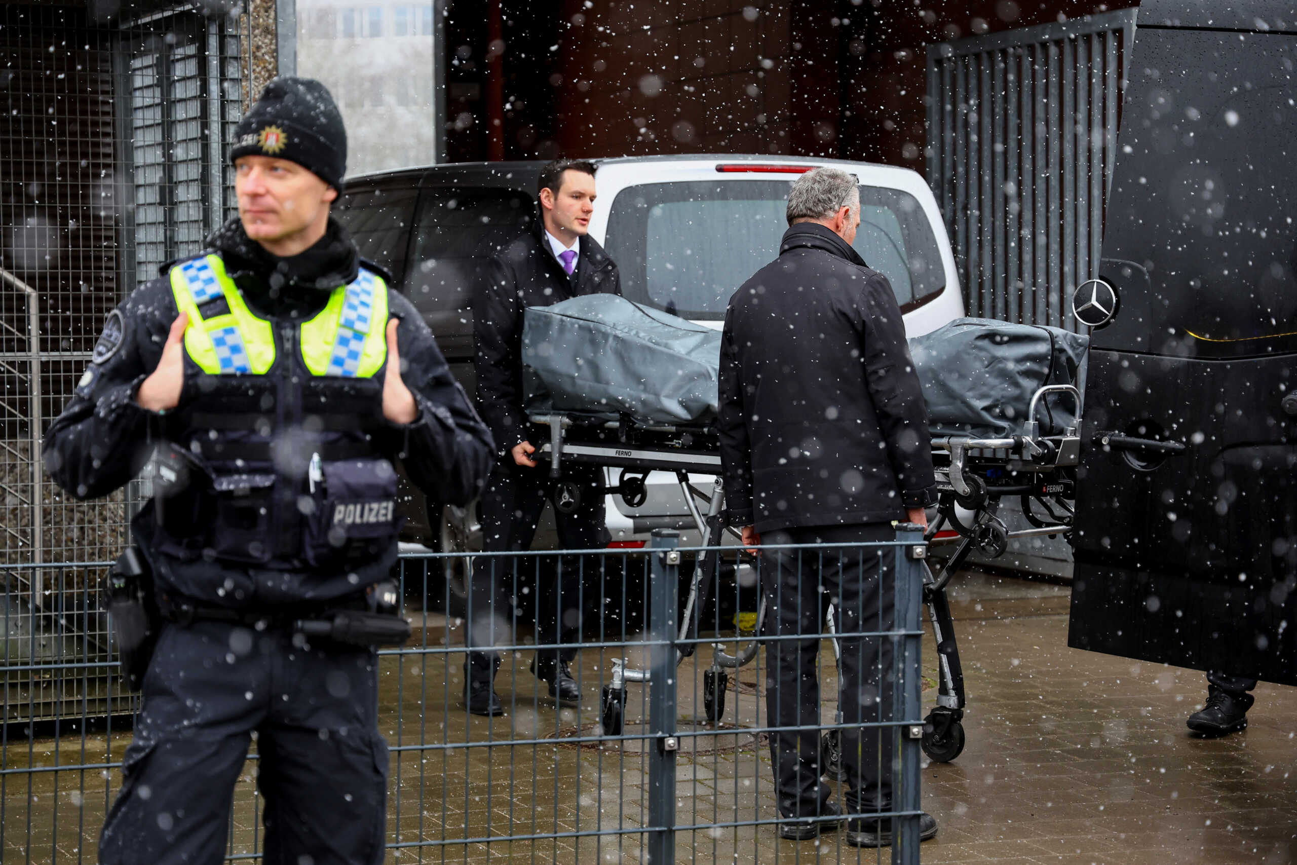 Undertakers transport the body of a victim of a deadly shooting at a building housing a Kingdom Hall of Jehovah's Witnesses, in Hamburg, northern Germany, March 10, 2023. REUTERS