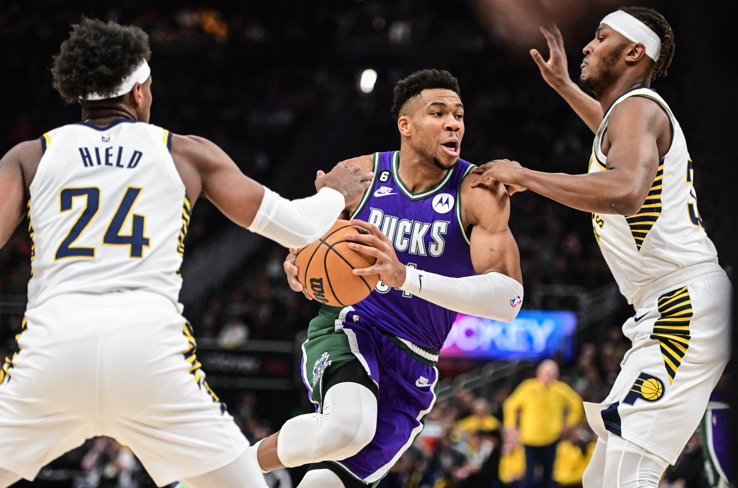 Mar 16, 2023; Milwaukee, Wisconsin, USA; Milwaukee Bucks forward Giannis Antetokounmpo (34) drives for the basket between Indiana Pacers guard Buddy Hield (24) and Indiana Pacers center Myles Turner (33) in the first quarter at Fiserv Forum. Mandatory Credit: Benny Sieu-USA TODAY Sports