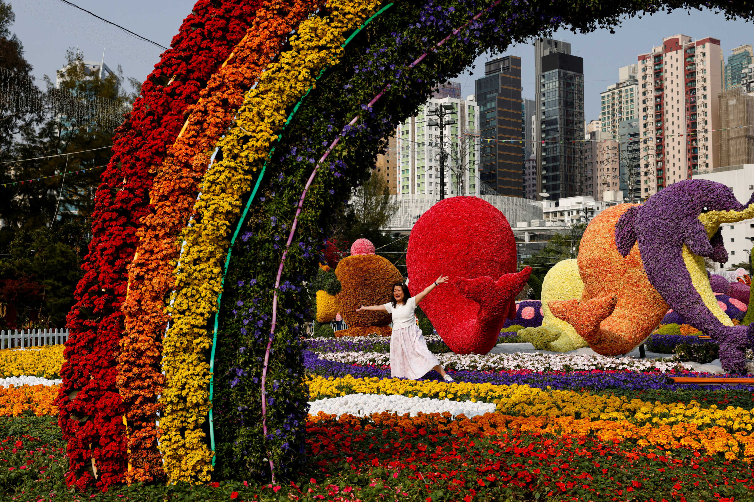 A woman poses for photos at the annual Flower Show in Hong Kong, China, March 9, 2023. REUTERS