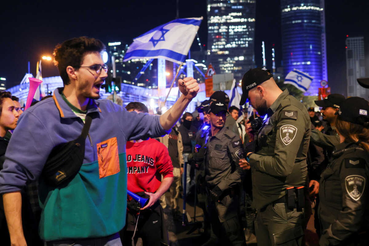People protest in front of police officers during a demonstration as Israeli Prime Minister Benjamin Netanyahu's nationalist coalition government presses on with its contentious judicial overhaul, in Tel Aviv, Israel, March 11, 2023. REUTERS