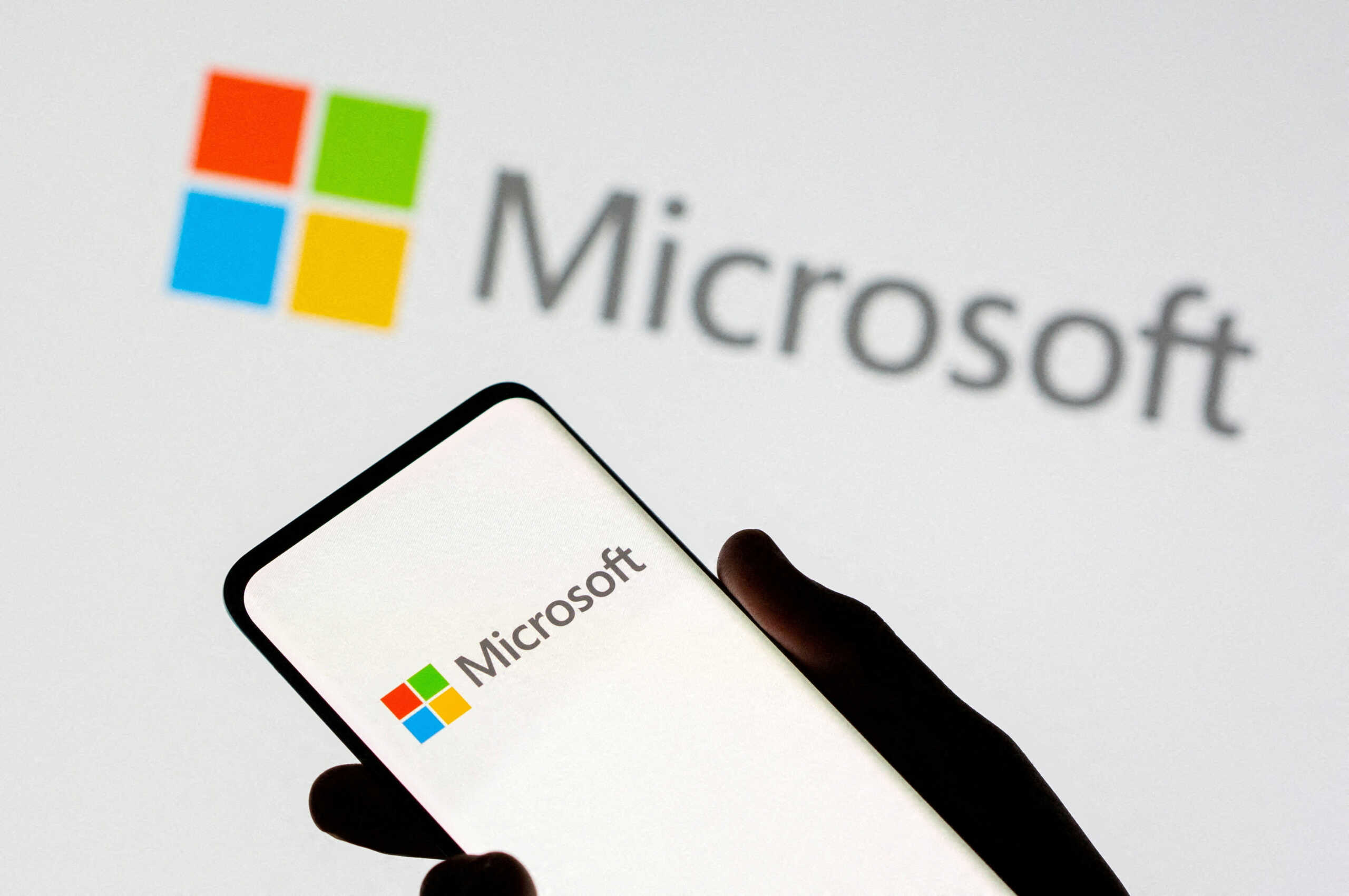 FILE PHOTO: Smartphone is seen in front of Microsoft logo displayed in this illustration taken, July 26, 2021. REUTERS