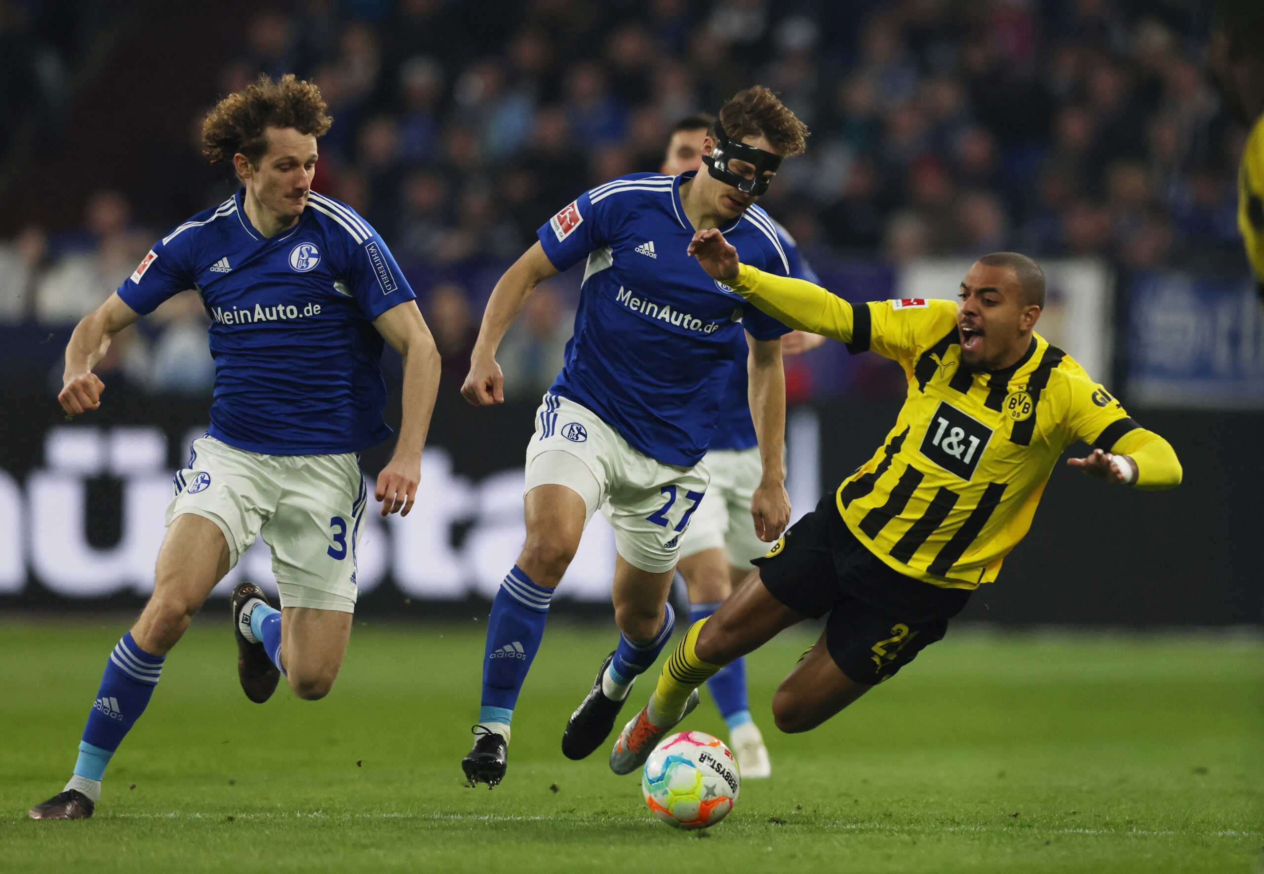 Soccer Football - Bundesliga - Schalke 04 v Borussia Dortmund - Veltins-Arena, Gelsenkirchen, Germany - March 11, 2023 Schalke 04's Alex Kral and Cedric Brunner in action with Borussia Dortmund's Donyell Malen REUTERS