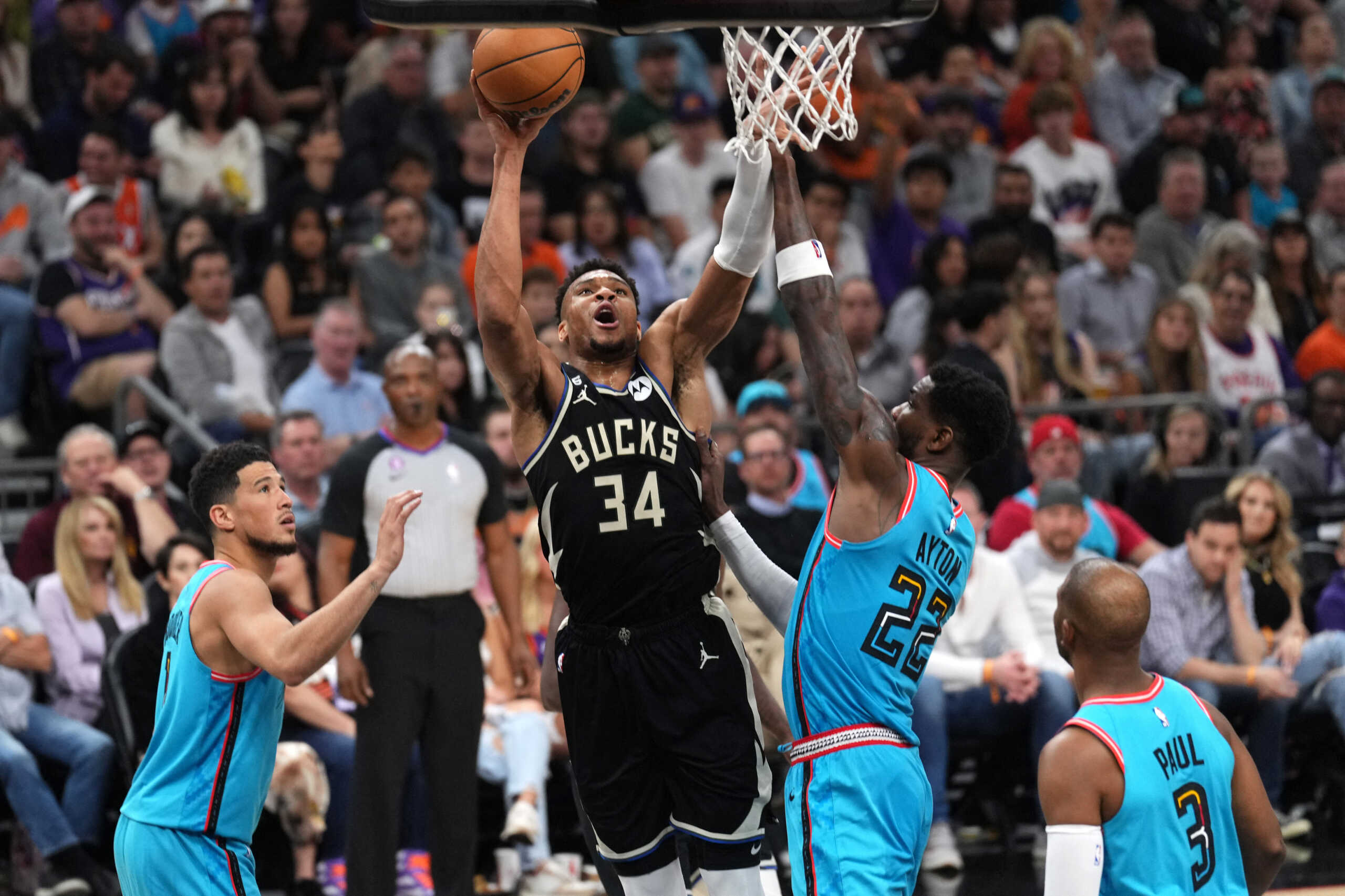 Mar 14, 2023; Phoenix, Arizona, USA; Milwaukee Bucks forward Giannis Antetokounmpo (34) shoots over Phoenix Suns center Deandre Ayton (22) during the first half at Footprint Center. Mandatory Credit: Joe Camporeale-USA TODAY Sports