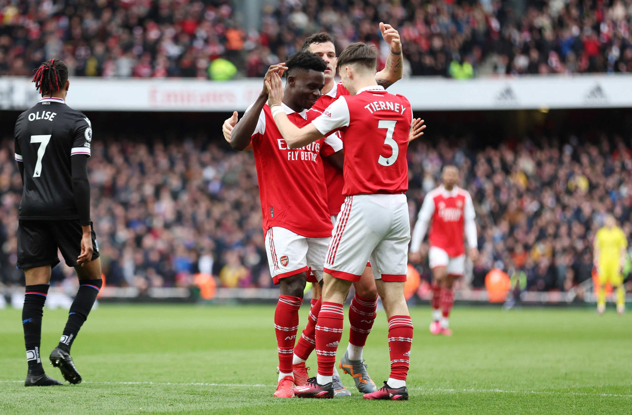Soccer Football - Premier League - Arsenal v Crystal Palace - Emirates Stadium, London, Britain - March 19, 2023 Arsenal's Bukayo Saka celebrates scoring their fourth goal with Kieran Tierney and Granit Xhaka REUTERS