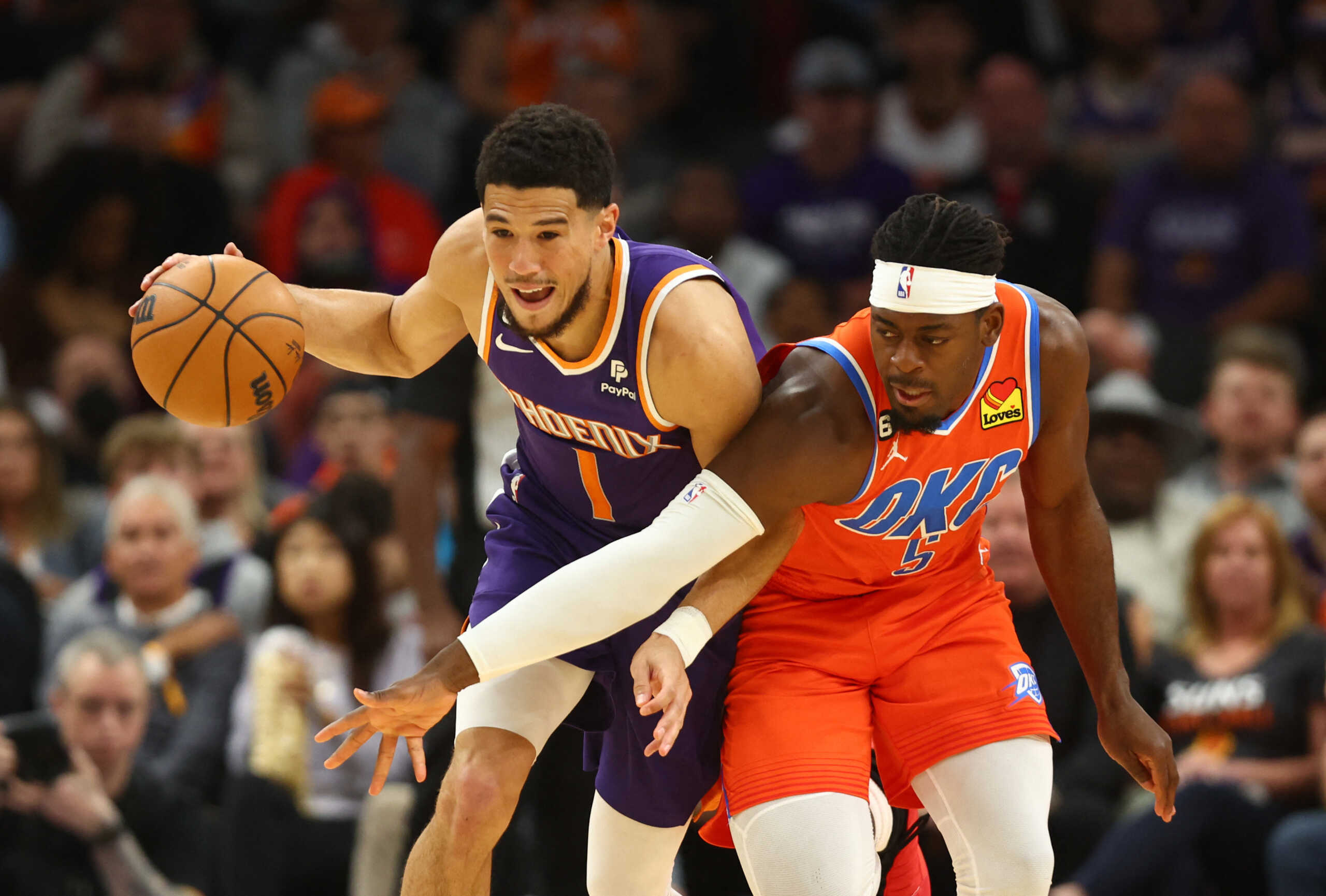 Mar 8, 2023; Phoenix, Arizona, USA; Phoenix Suns guard Devin Booker (1) moves the ball against Oklahoma City Thunder guard Luguentz Dort (5) in the first half at Footprint Center. Mandatory Credit: Mark J. Rebilas-USA TODAY Sports