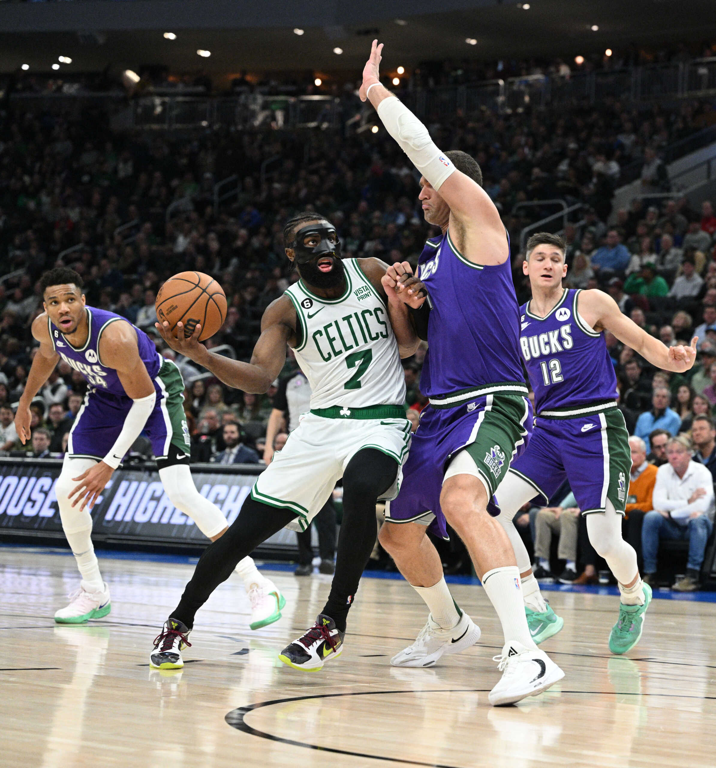 Mar 30, 2023; Milwaukee, Wisconsin, USA; Boston Celtics guard Jaylen Brown (7) drives to the basket against Milwaukee Bucks center Brook Lopez (11) at Fiserv Forum. Mandatory Credit: Michael McLoone-USA TODAY Sports