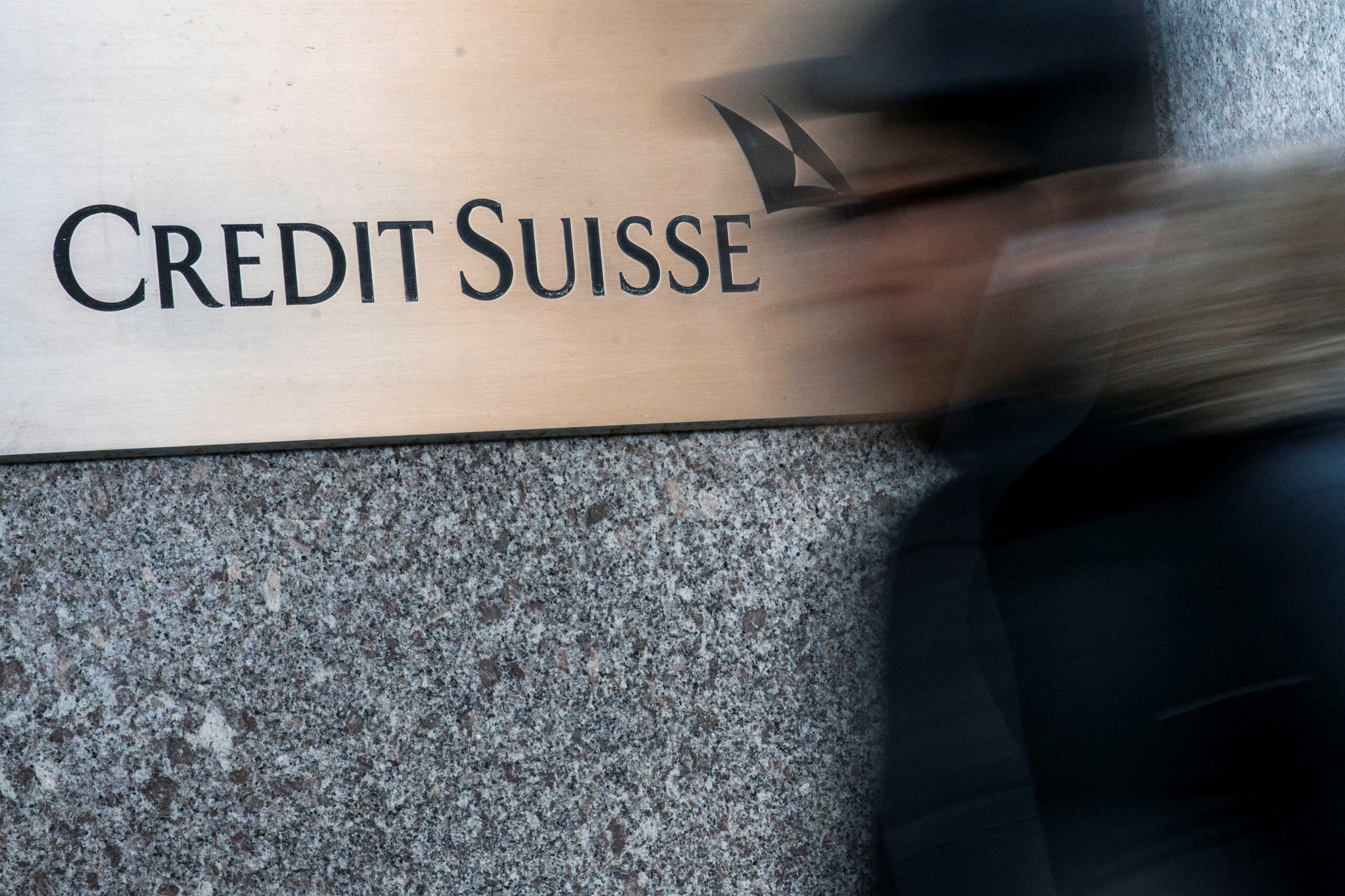 A man walks near Credit Suisse bank headquarters in New York City, U.S., March 15, 2023. REUTERS