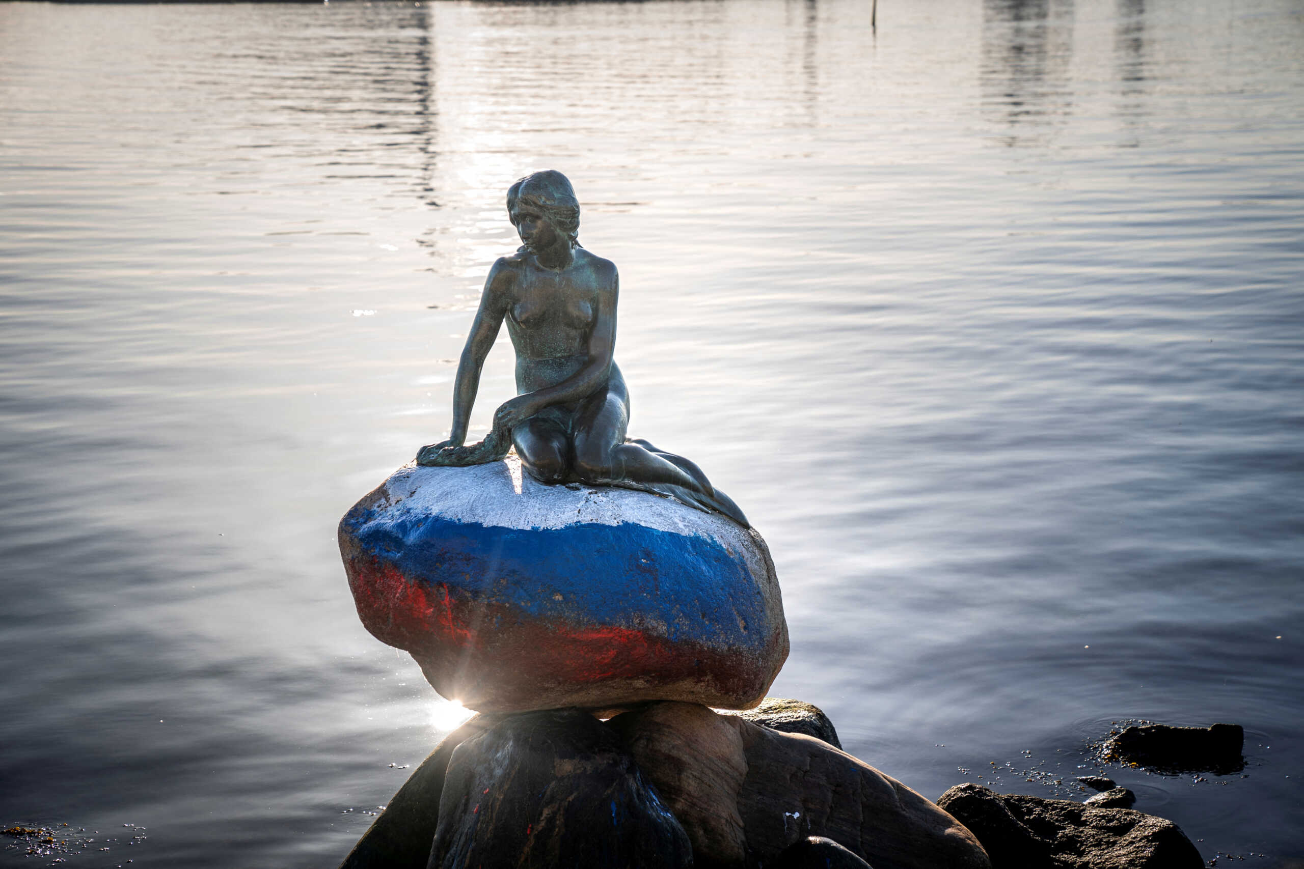 The Little Mermaid sculpture is seen vandalized with colours of the Russian flag painted on the stone she sits on, in Langelinie, Copenhagen, Denmark March 2, 2023. Ritzau Scanpix