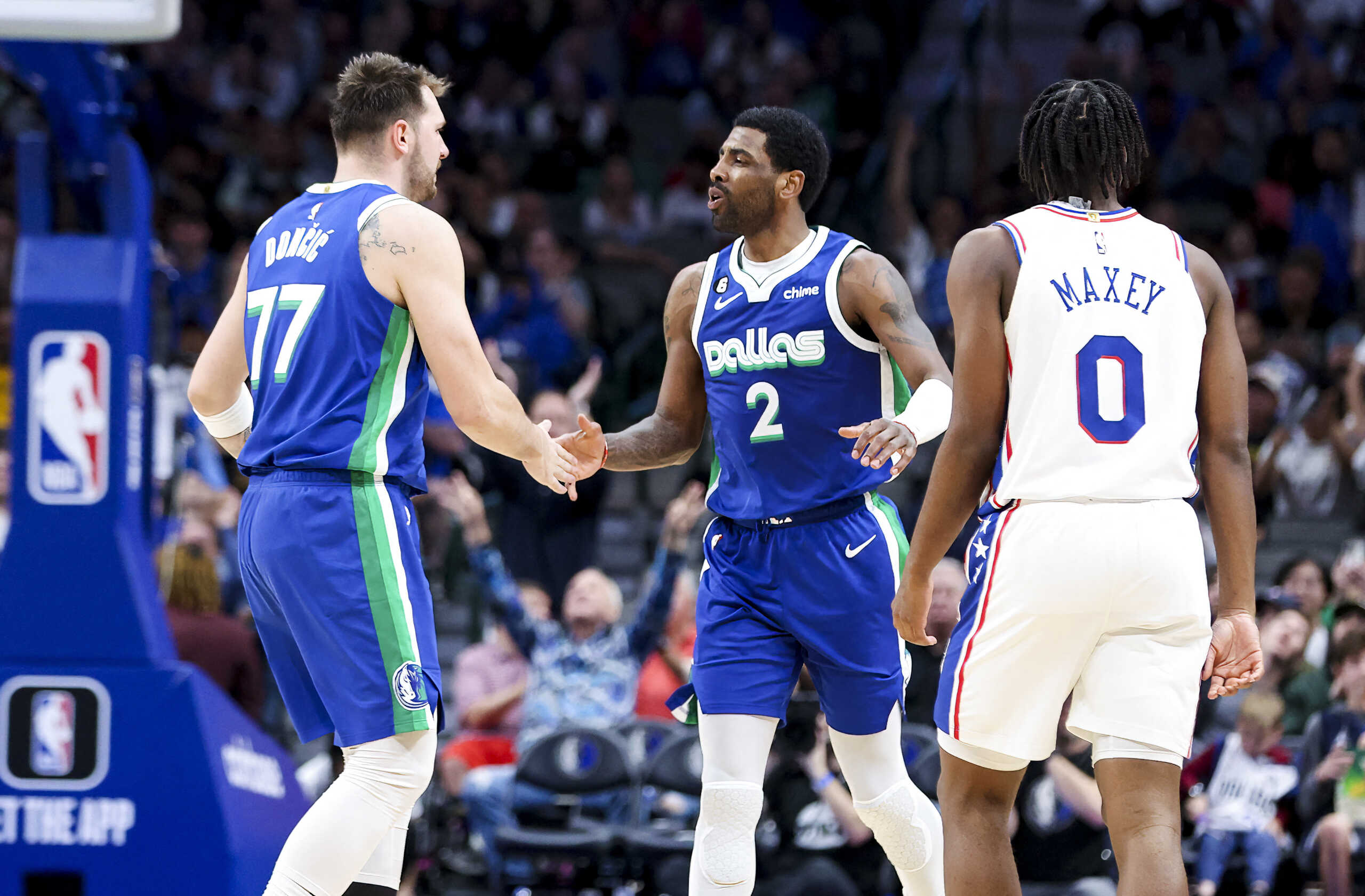 Mar 2, 2023; Dallas, Texas, USA;  Dallas Mavericks guard Luka Doncic (77) celebrates with Dallas Mavericks guard Kyrie Irving (2) in front of Philadelphia 76ers guard Tyrese Maxey (0) during the second half at American Airlines Center. Mandatory Credit: Kevin Jairaj-USA TODAY Sports
