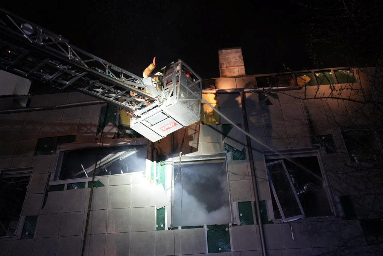 Rescuers work at the site where a building was damaged in the night by Russian drone strikes, amid Russia's attack on Ukraine, in Kyiv, Ukraine March 28, 2023. Press service of the State Emergency Service of Ukraine
